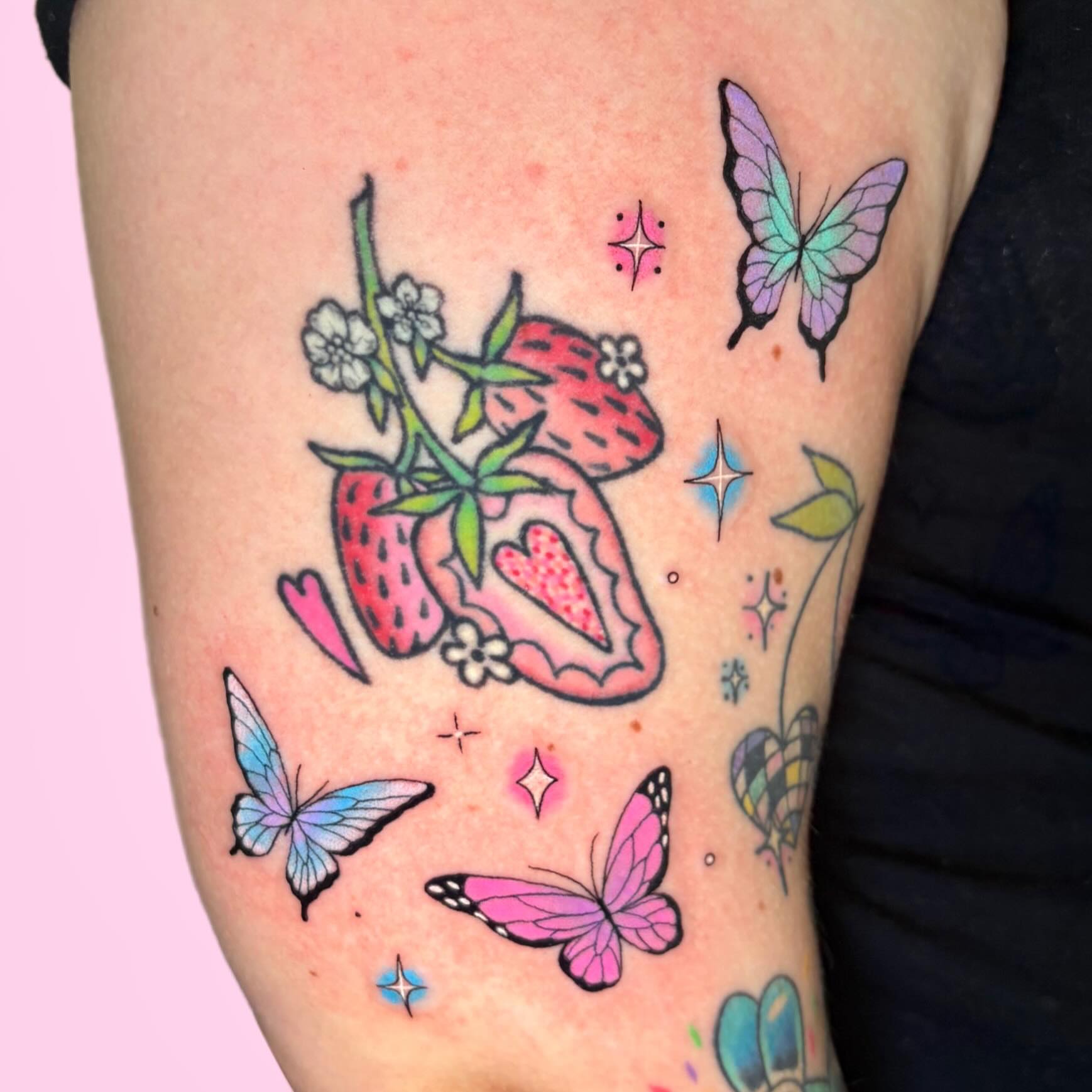 Strawberries and butterflies new school tattoo on the thigh by Juliet Miller