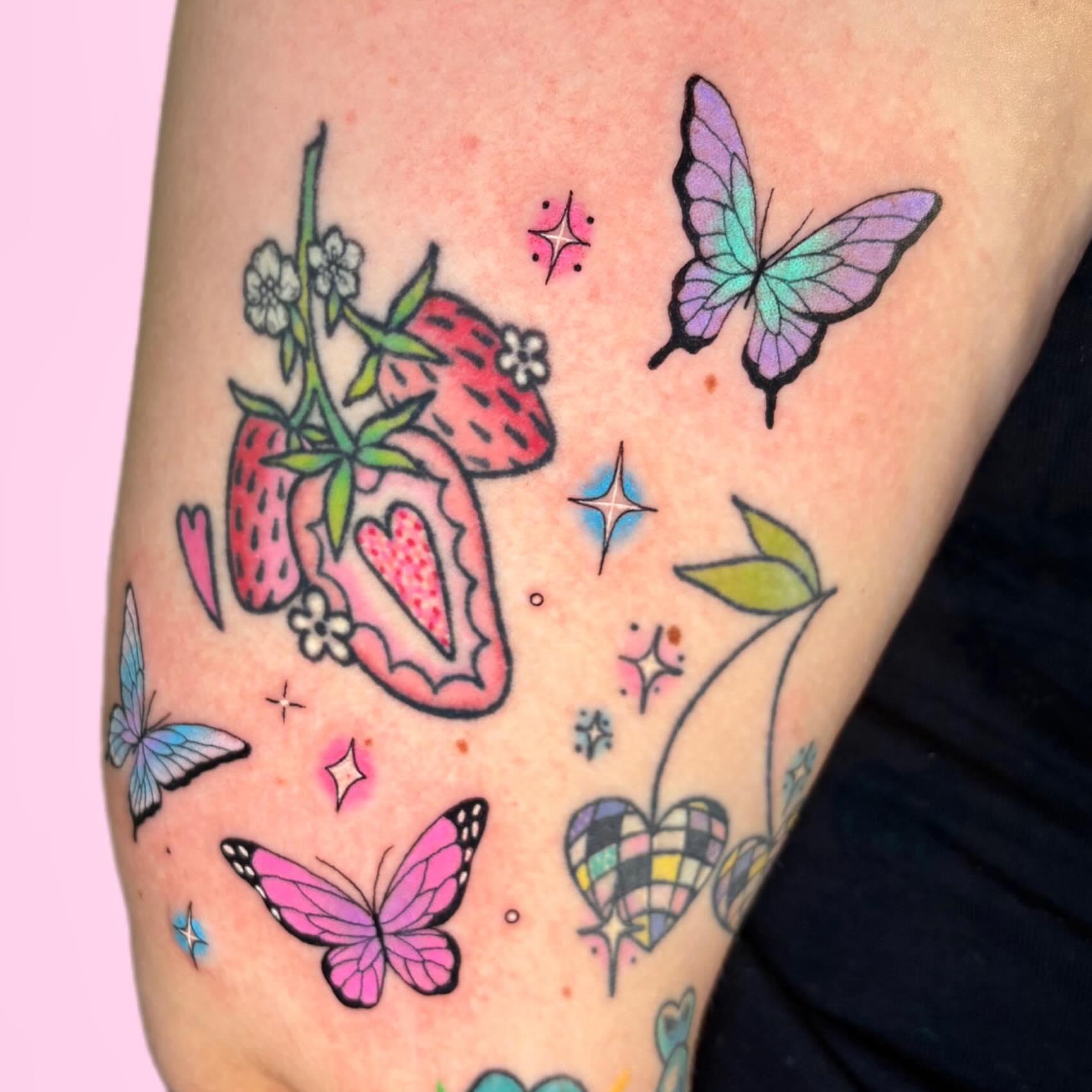 Strawberries and butterflies American traditional tattoo on the forearm by Juliet Miller