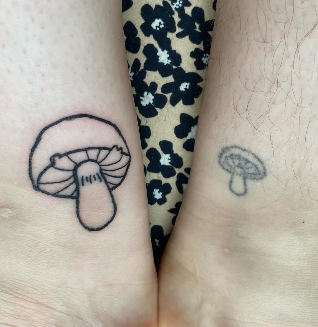 Two mushroom outlines minimalist tattoo on the hand by ollie, Portland, Oregon