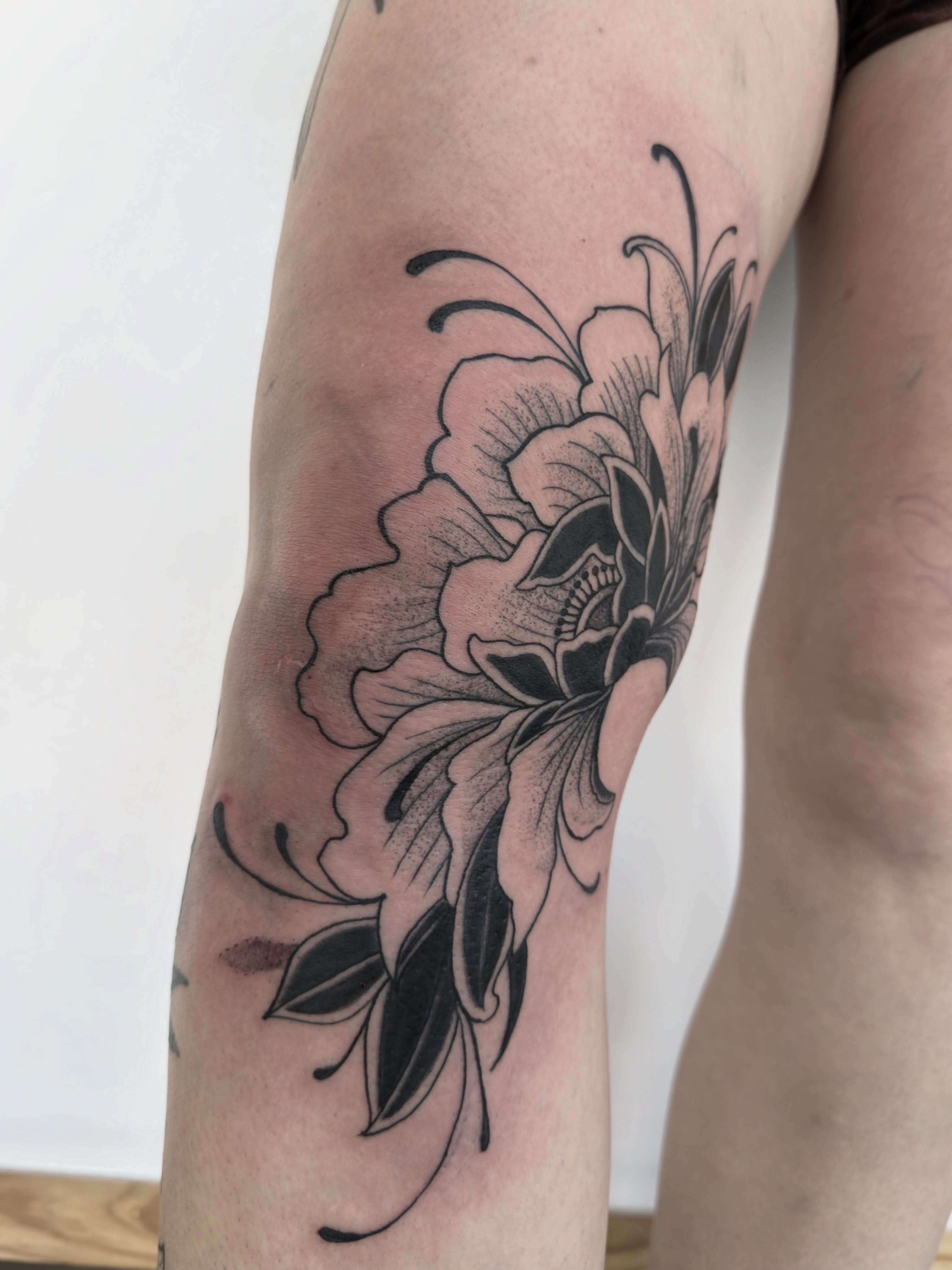 Floral arrangement black and grey tattoo on the forearm by Christopher Layman