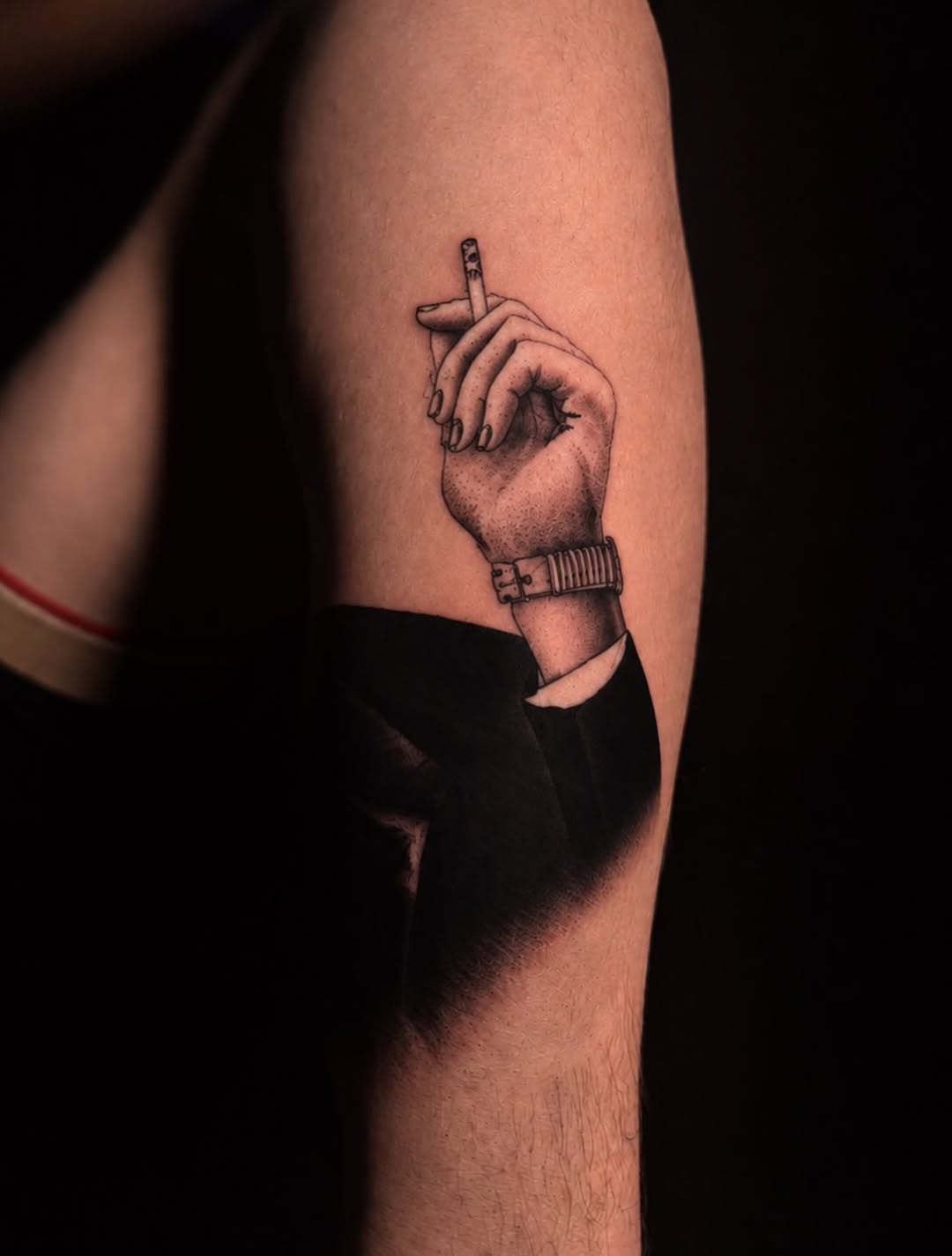 Hand holding a cigarette surrealism tattoo on the forearm by LeLe