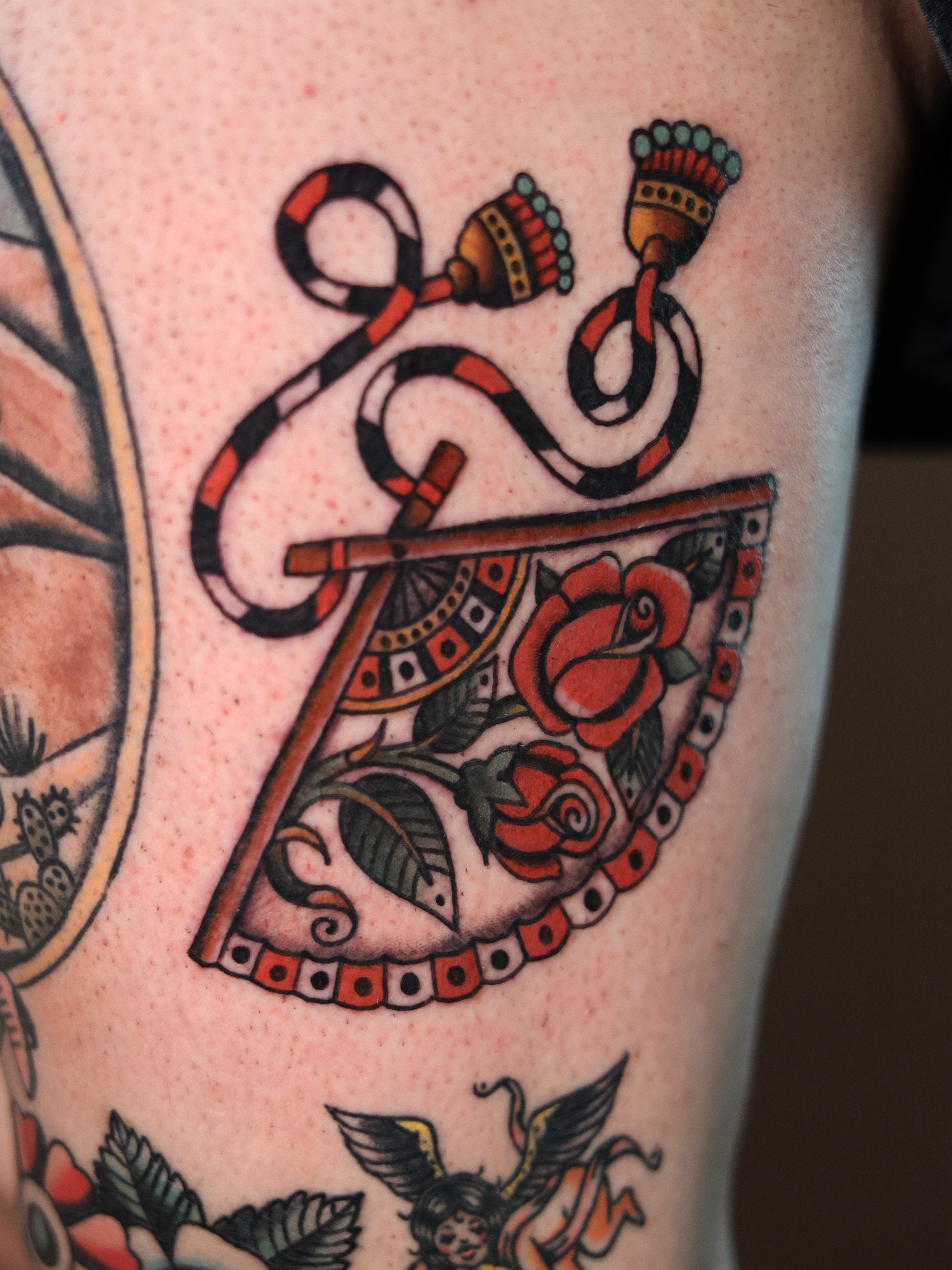 Rose and snake American traditional tattoo on the forearm by Dylan Mott