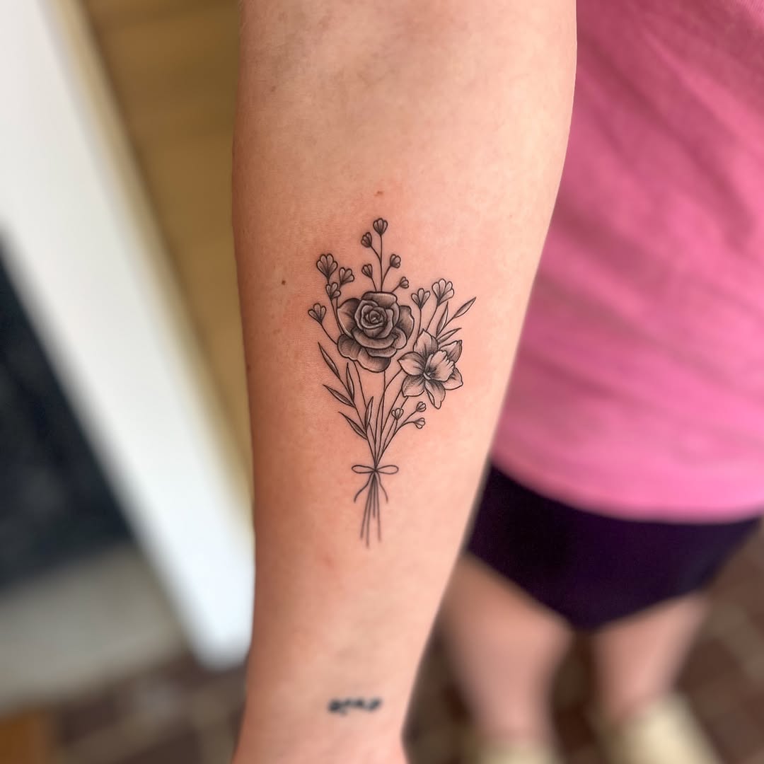 Bouquet of flowers fine line tattoo on the forearm by Jai Woods