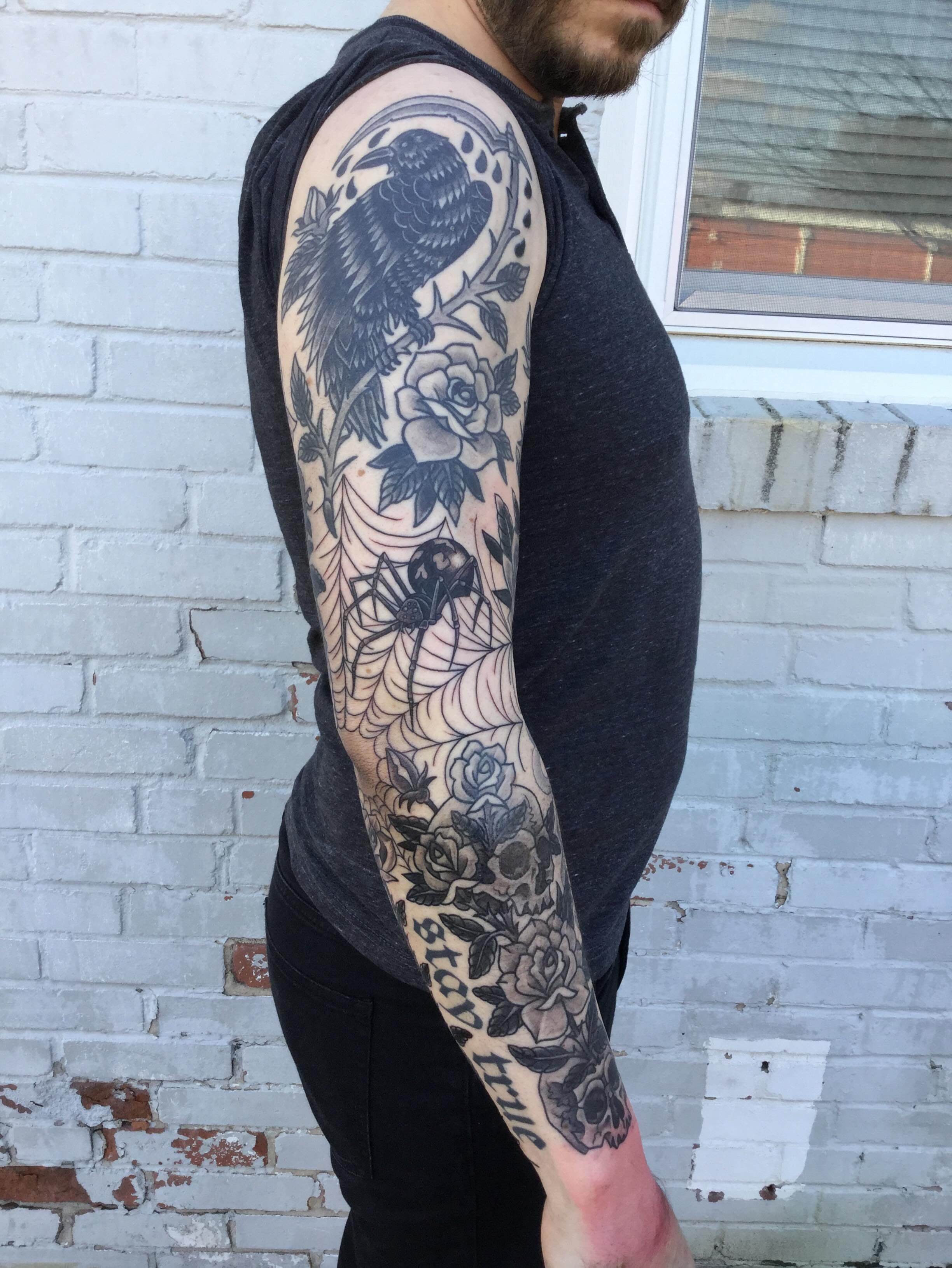 Crow and roses American traditional tattoo on the upper arm by Ravi Chandra, Mount Shasta, California