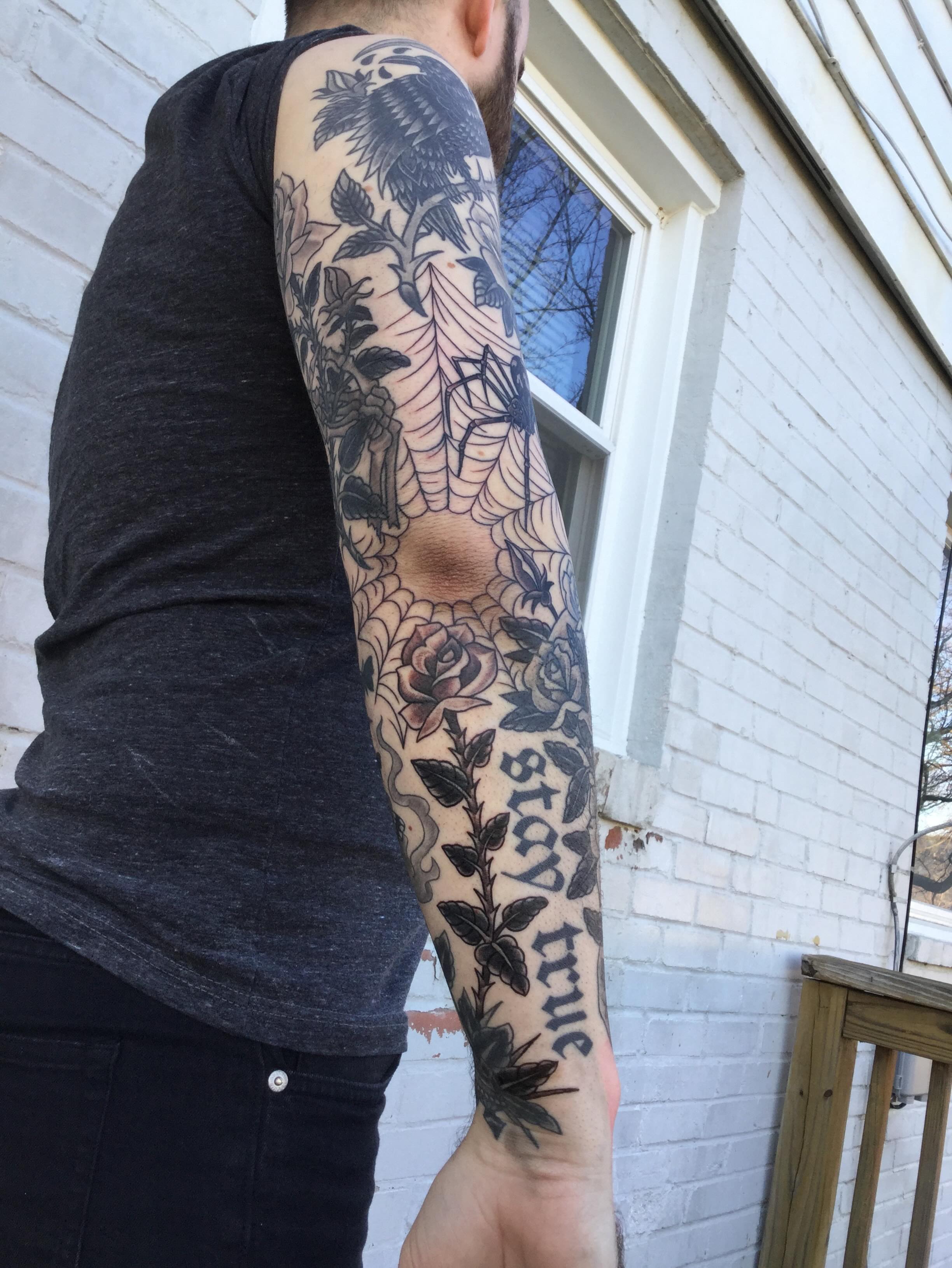 Floral and spiderweb American traditional tattoo on the forearm by Ravi Chandra, Mount Shasta, California