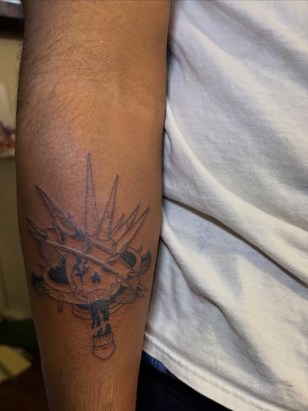 Skull with crown and spikes tattoo on the forearm by winrytattoome