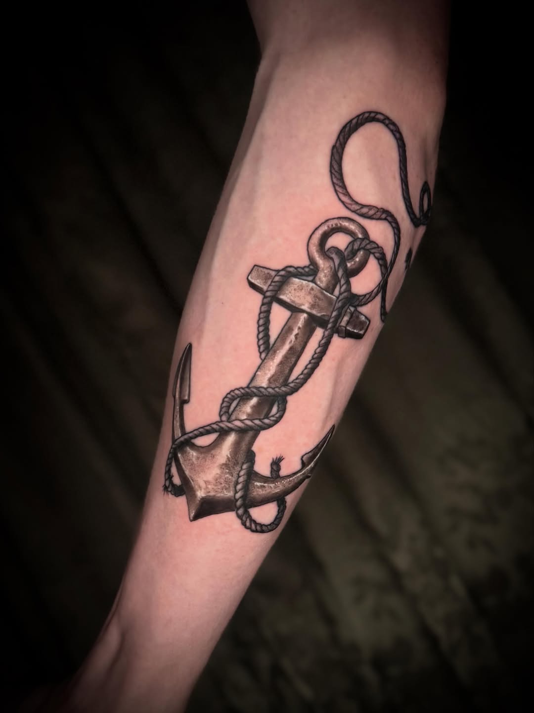 Anchor with rope surrealism tattoo on the forearm by Terence Taylor