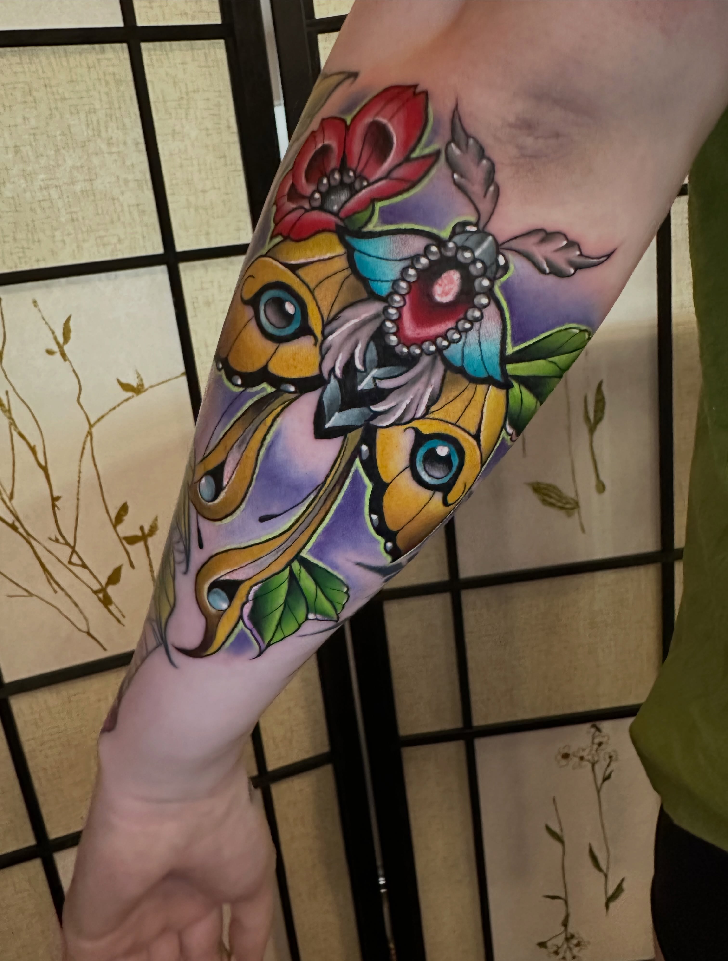 Butterfly and flowers American traditional tattoo on the forearm by Sam AlpineInk