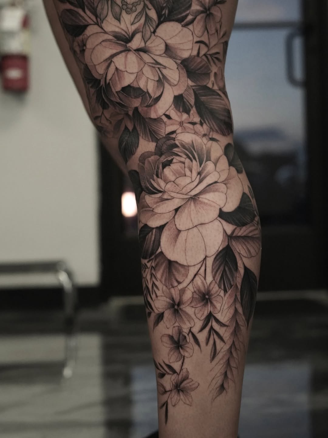 Floral arrangement dotwork tattoo on the calf by Nelson Tellez