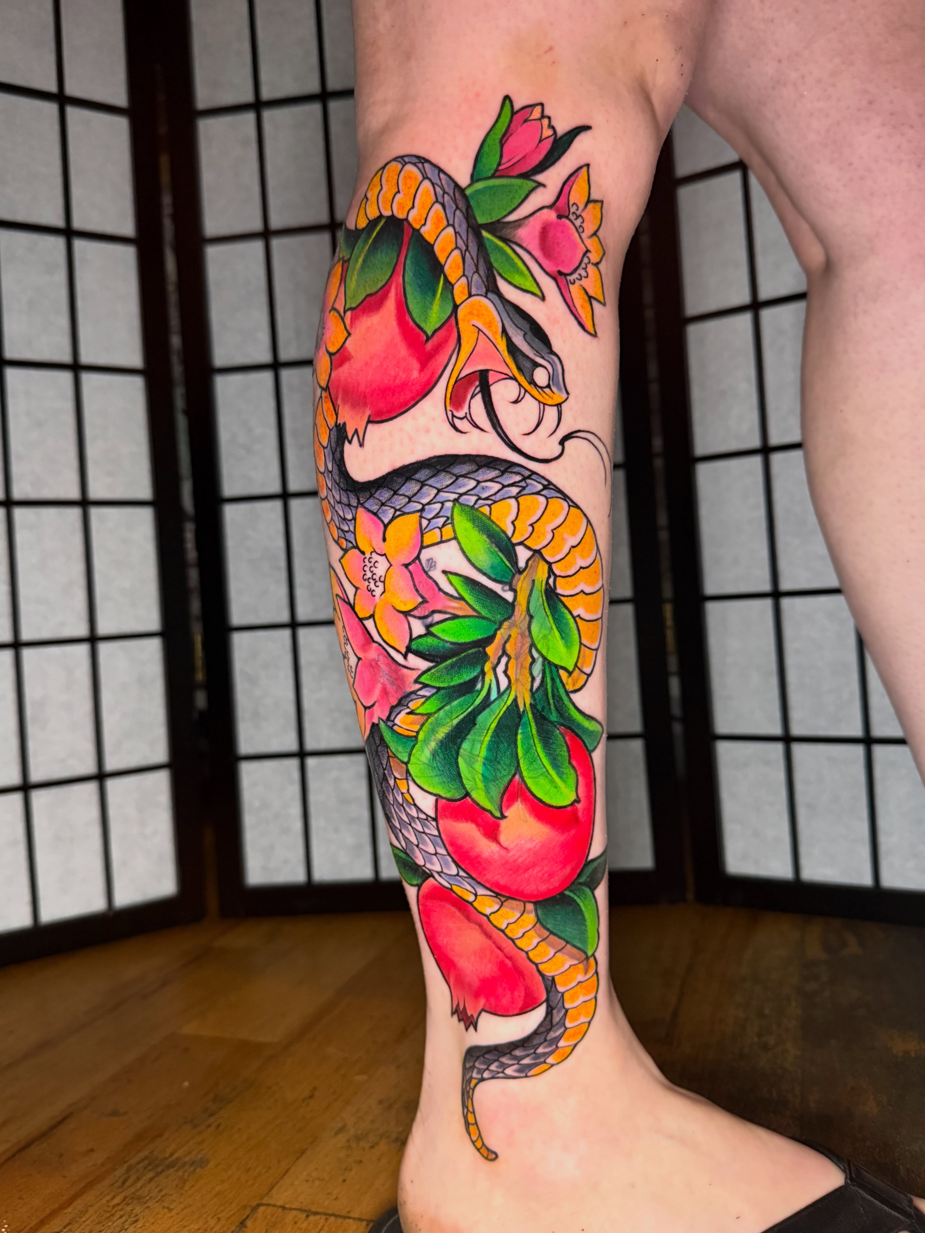 Snake and peach American traditional tattoo on the calf by Kevin R. Onley