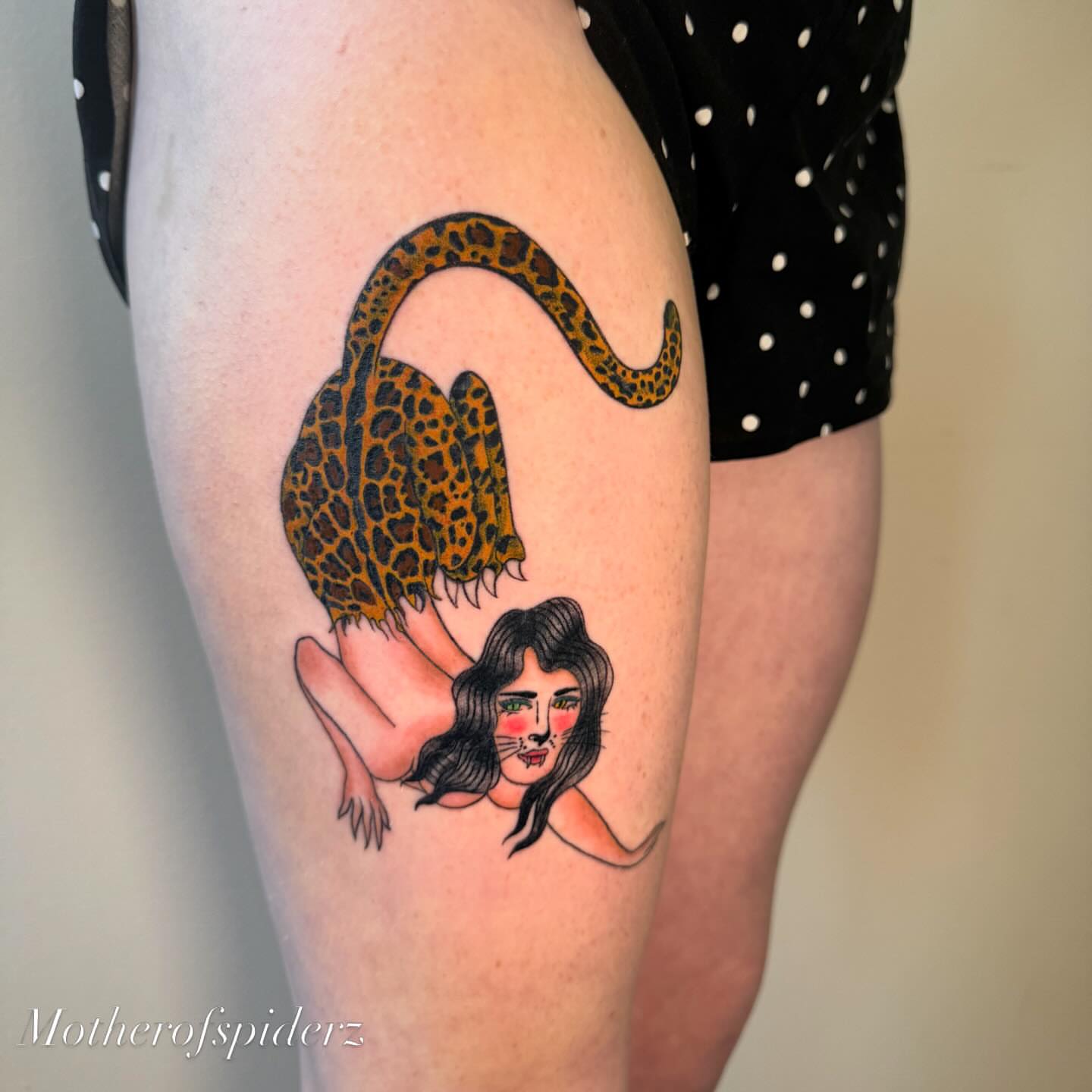 Woman with leopard illustrative tattoo on the thigh by Alyssa Garza