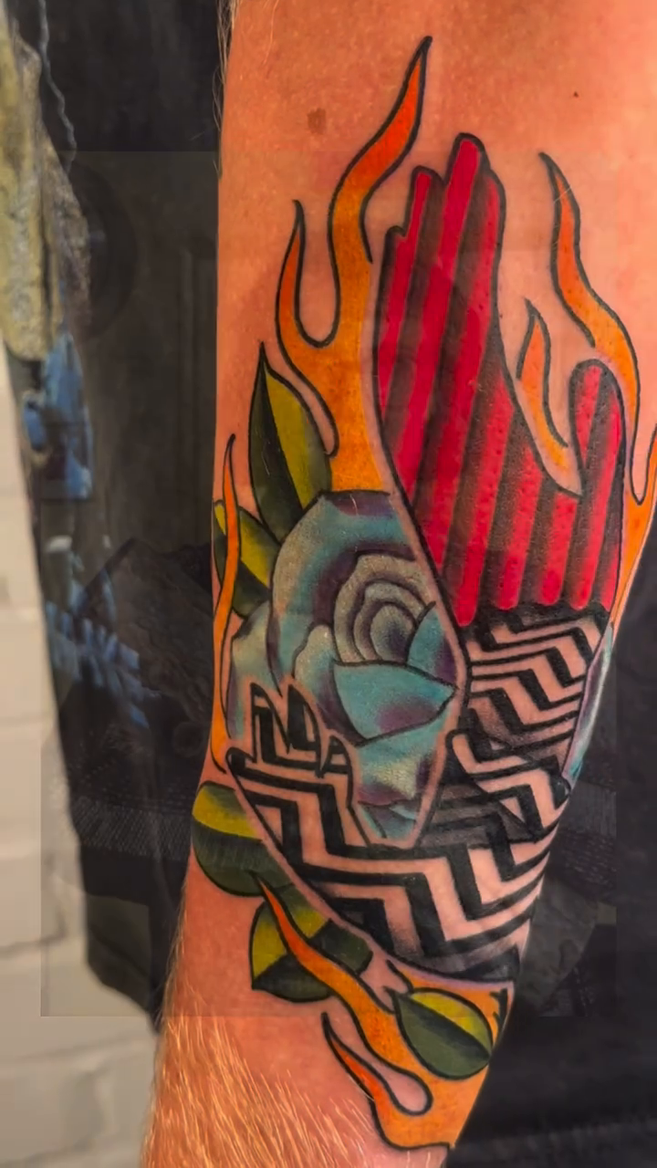 Flaming rose and abstract pattern surrealism tattoo on the forearm by Alex Passapera