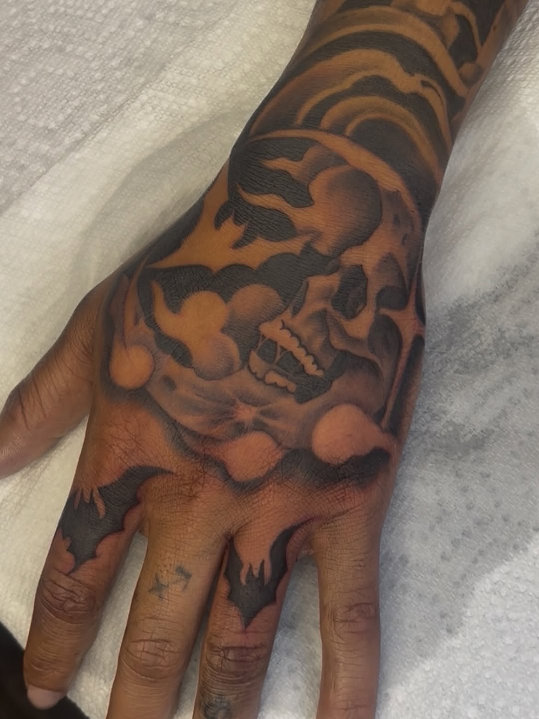 Skull and bats dark art tattoo on the hand by Terrence jones
