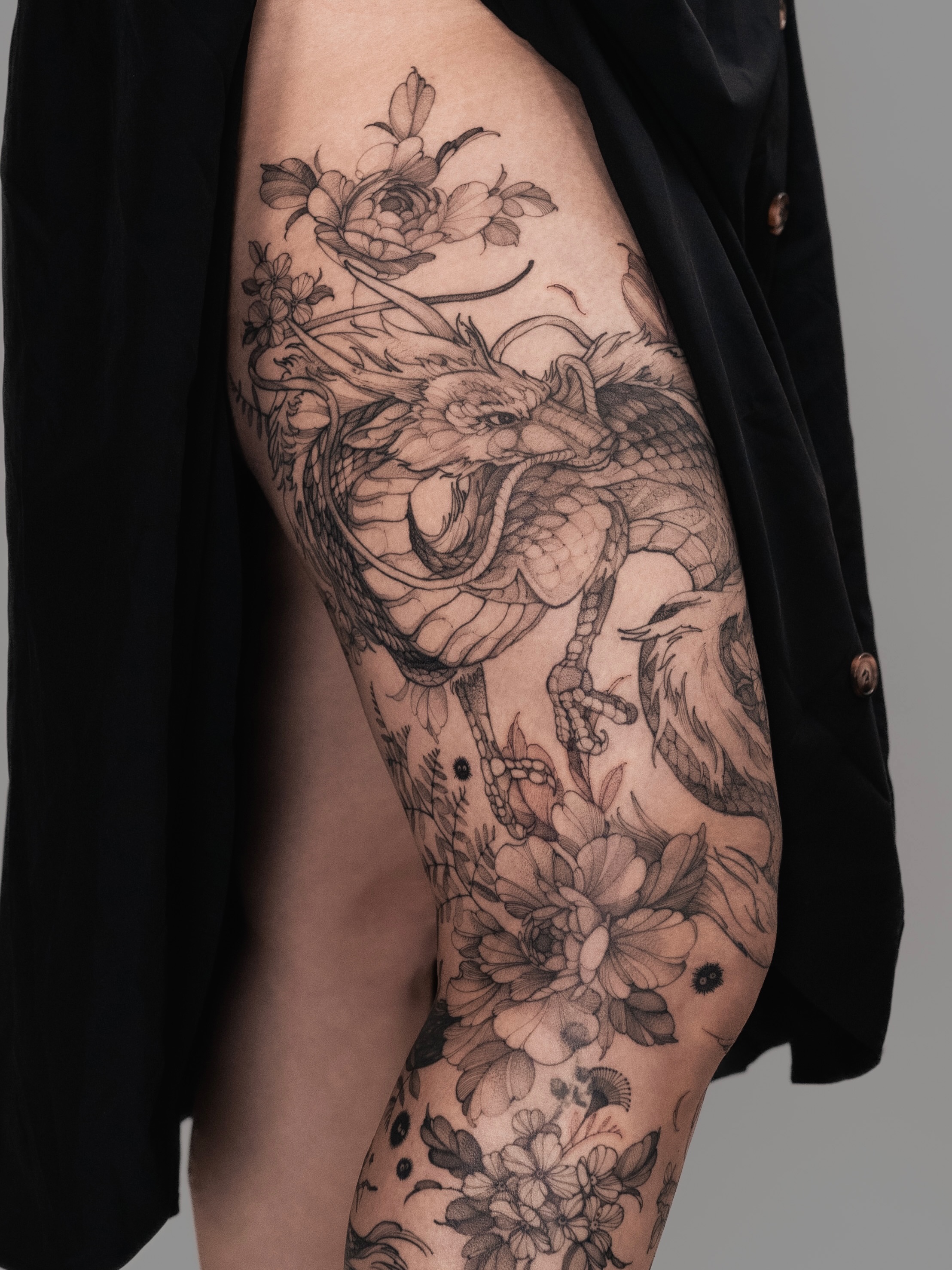Dragon and floral realism tattoo on the thigh by Yuliia Babych tattoo AUSTIN