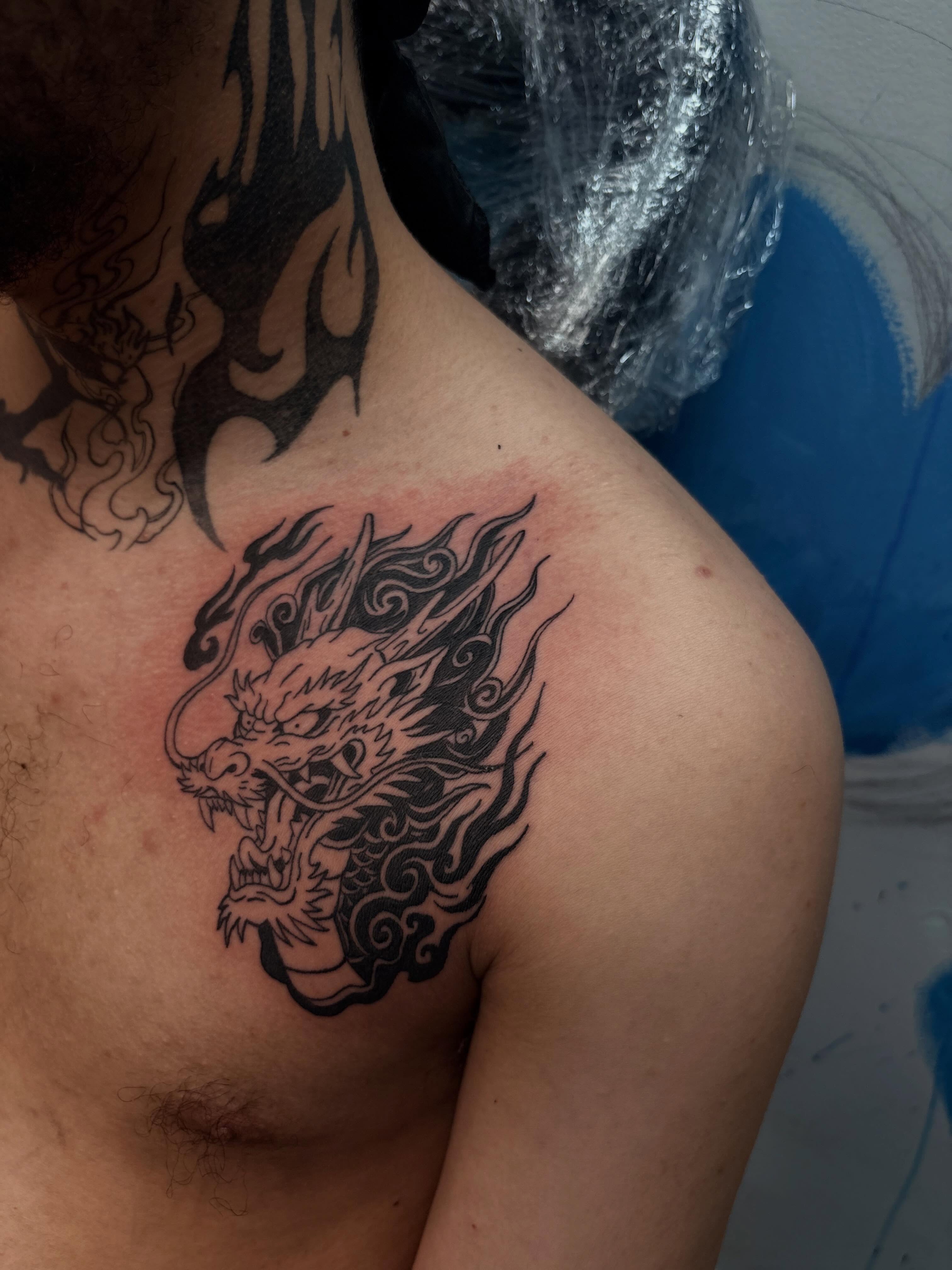 Dragon head black and grey tattoo on the shoulder by 𝓚𝓪𝓻𝓶𝓪💫