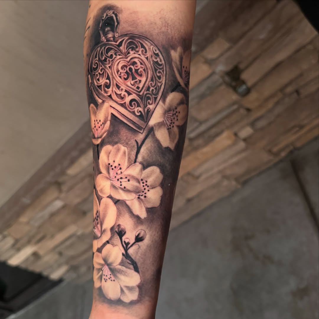 Heart and flowers realism tattoo on the forearm by Faith Lopez