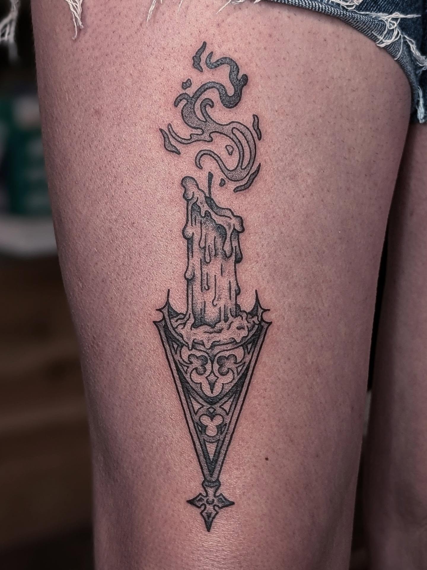 Candle and dagger black and grey tattoo on the thigh by ᴇʟɪsᴇ