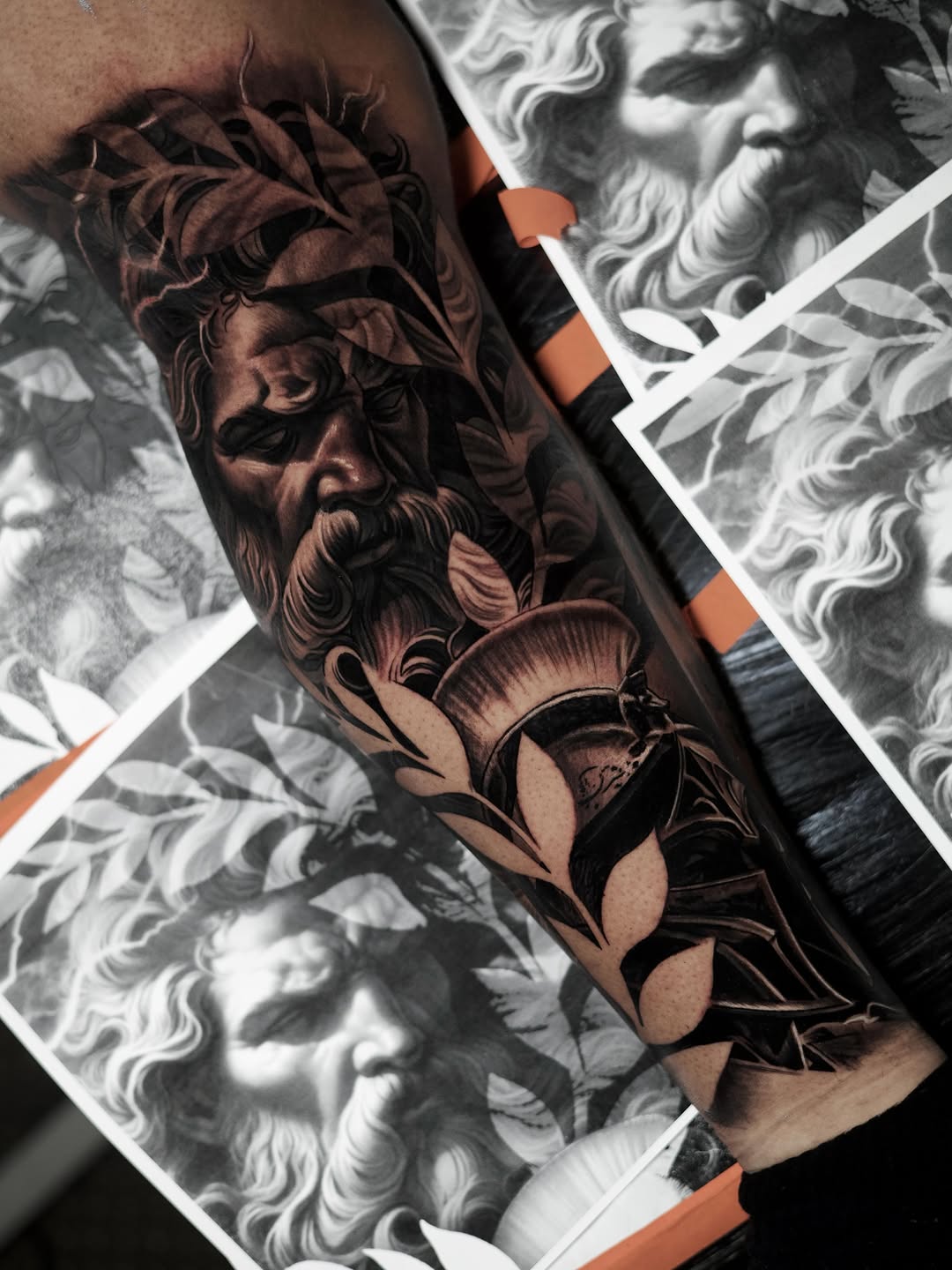 Greek god portrait with leaves realism tattoo on the forearm by Bapone