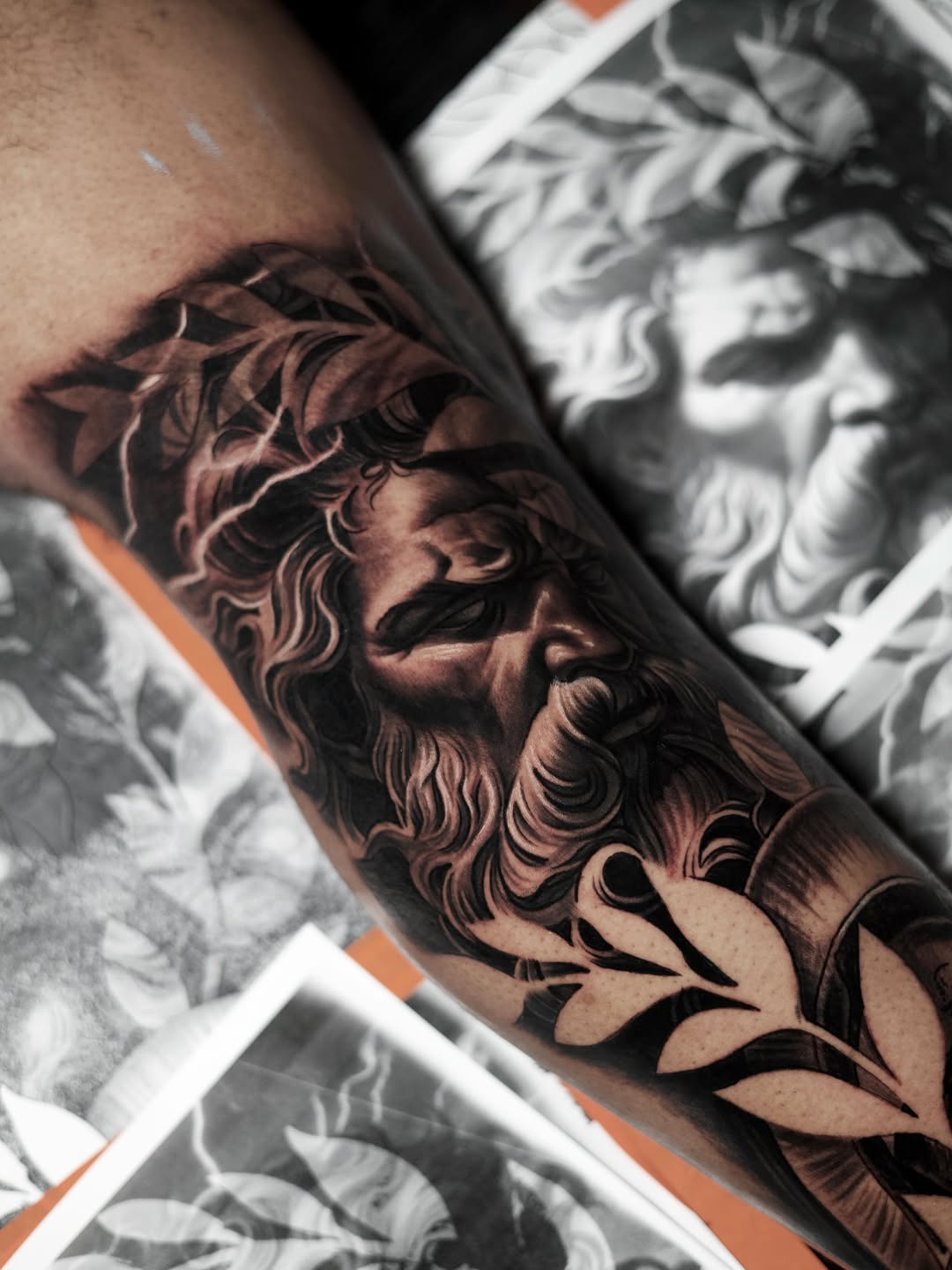 Zeus portrait with laurel wreath realism tattoo on the forearm by Bapone