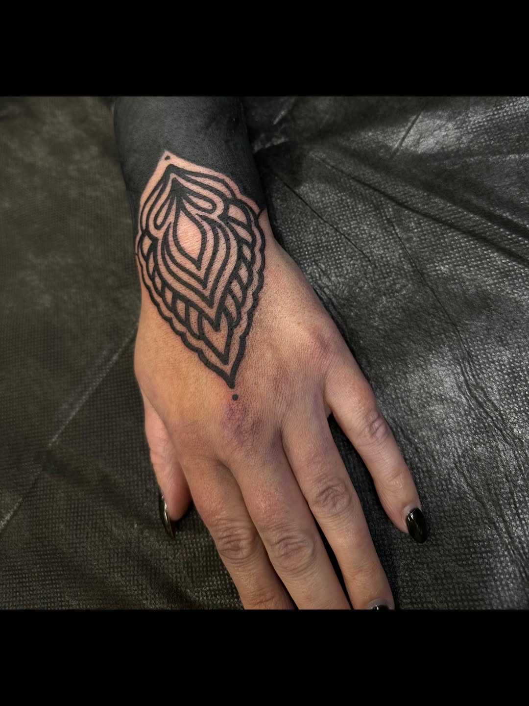 Ornamental pattern on hand and forearm dotwork tattoo on the hand by Ciera Farni, Murray, Utah