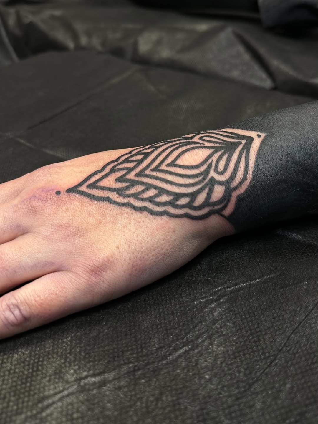 Geometric pattern on forearm and hand dotwork tattoo on the hand by Ciera Farni, Murray, Utah