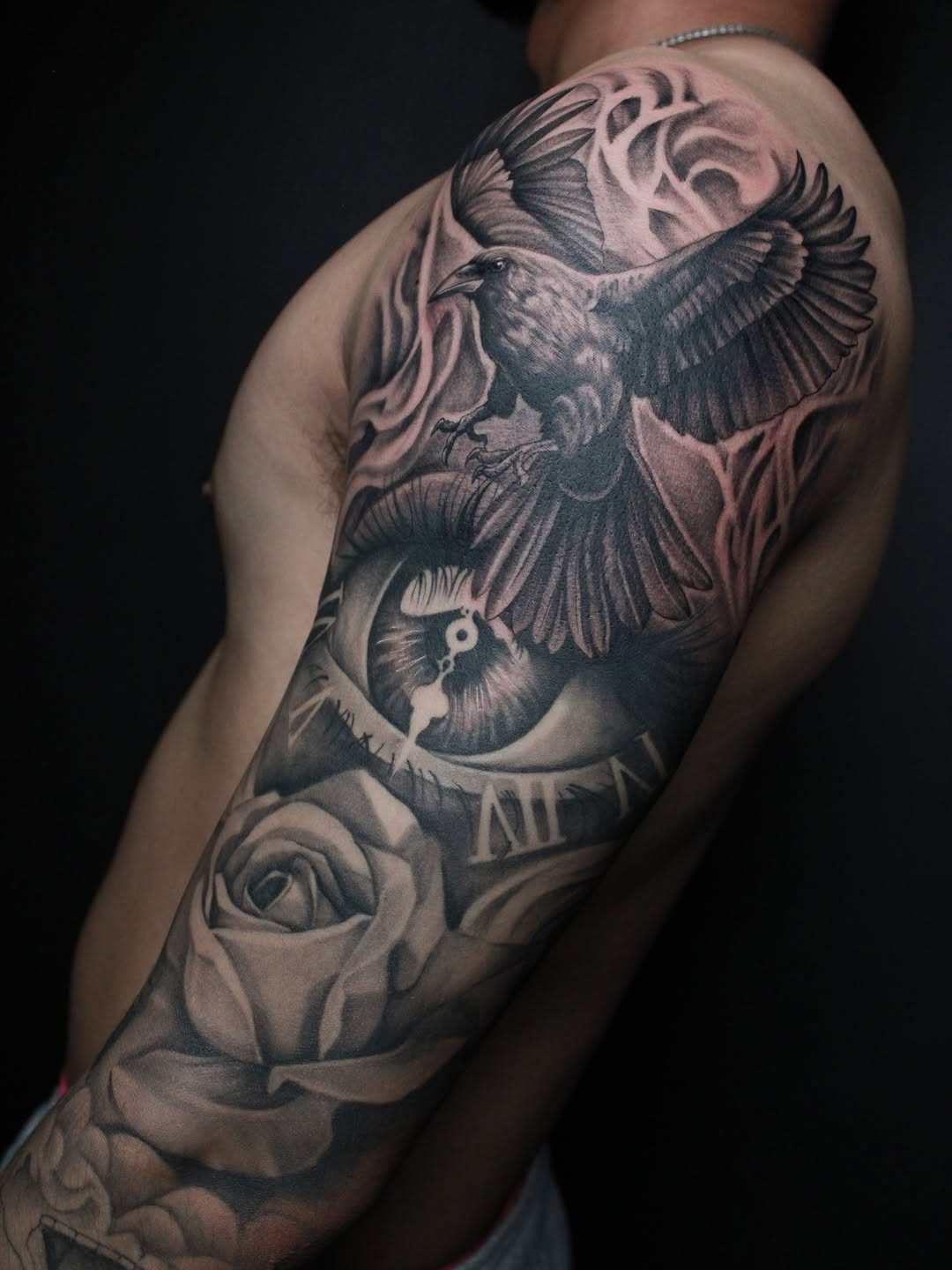 Raven, eye, and rose realism tattoo on the shoulder by 𝕵𝖎𝖒𝖎 𝕯𝖊𝕽𝖔𝖘𝖆🥀, Everett, Washington