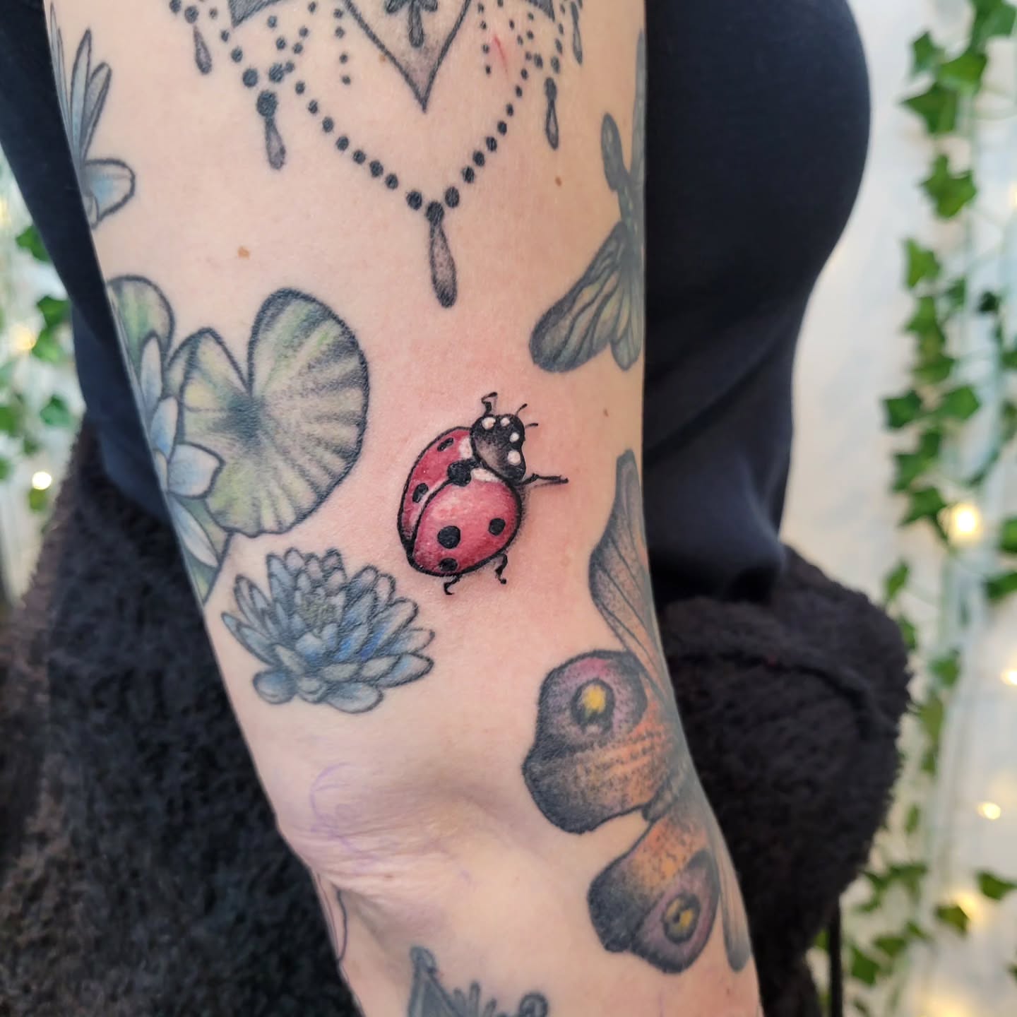 Ladybug dotwork tattoo on the forearm by Uku Tattoos, Cambridge, England