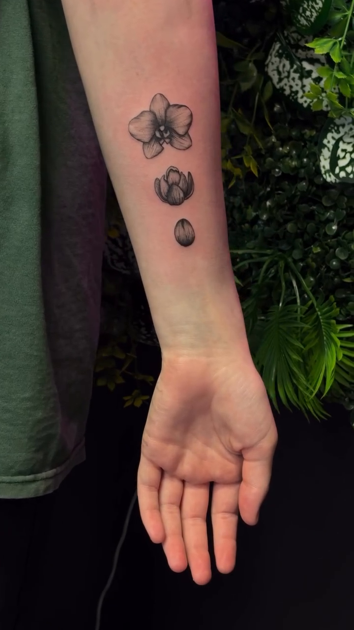 Three small orchids on forearm fine line tattoo on the forearm by Melissa