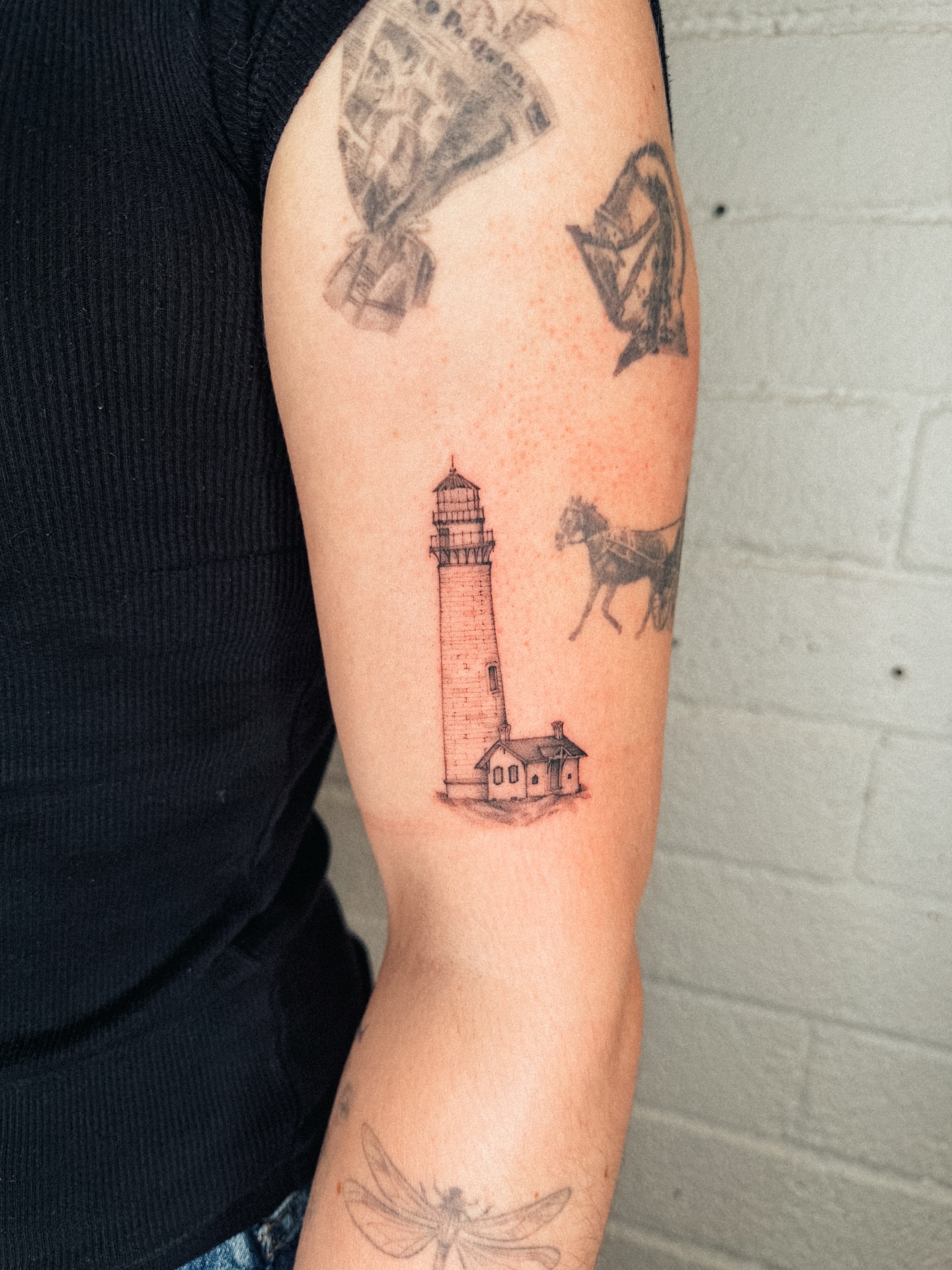 Lighthouse black and grey tattoo on the forearm by Emma- Los Angeles Tattoo Artist