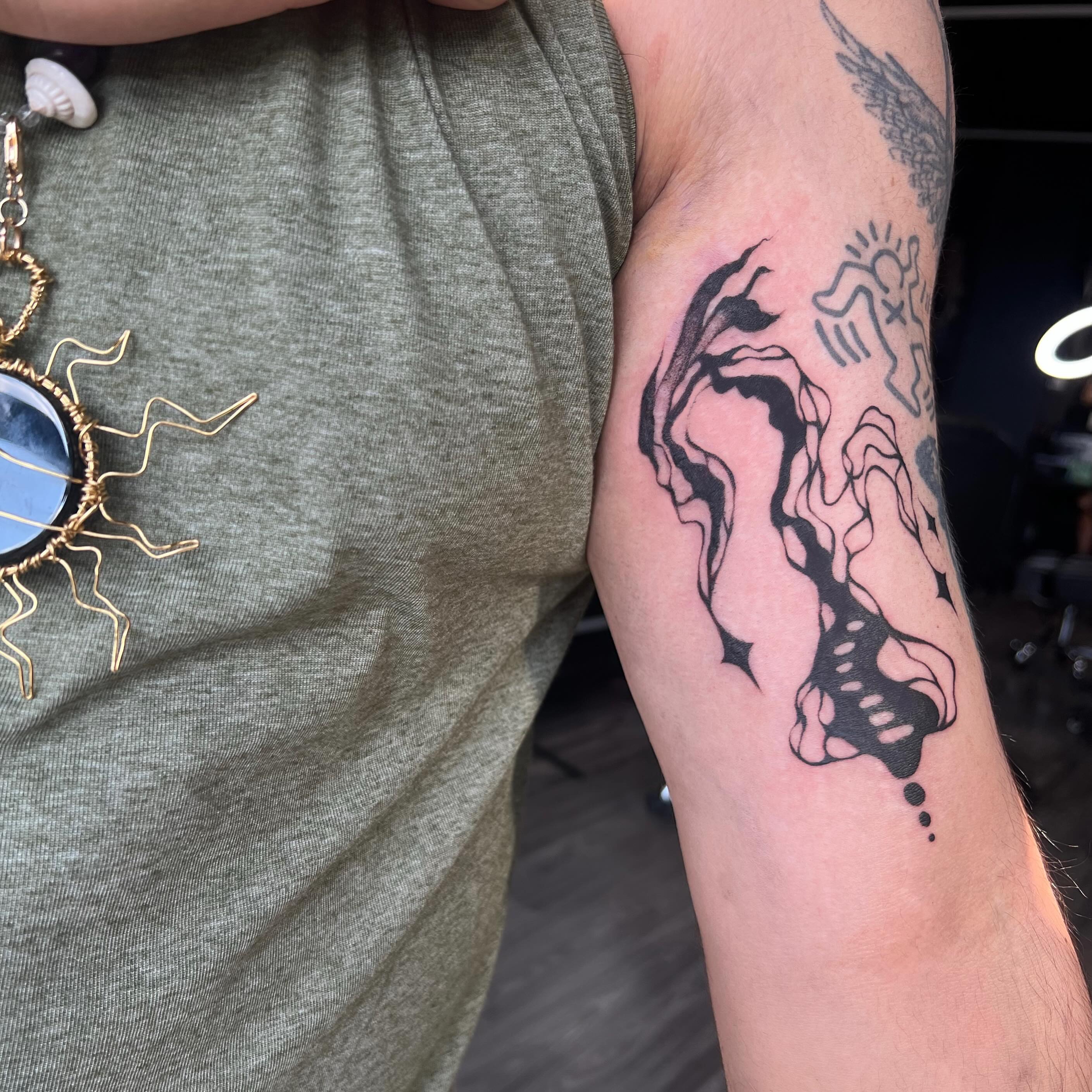 Abstract figure dotwork tattoo on the forearm by Haiiitattoo