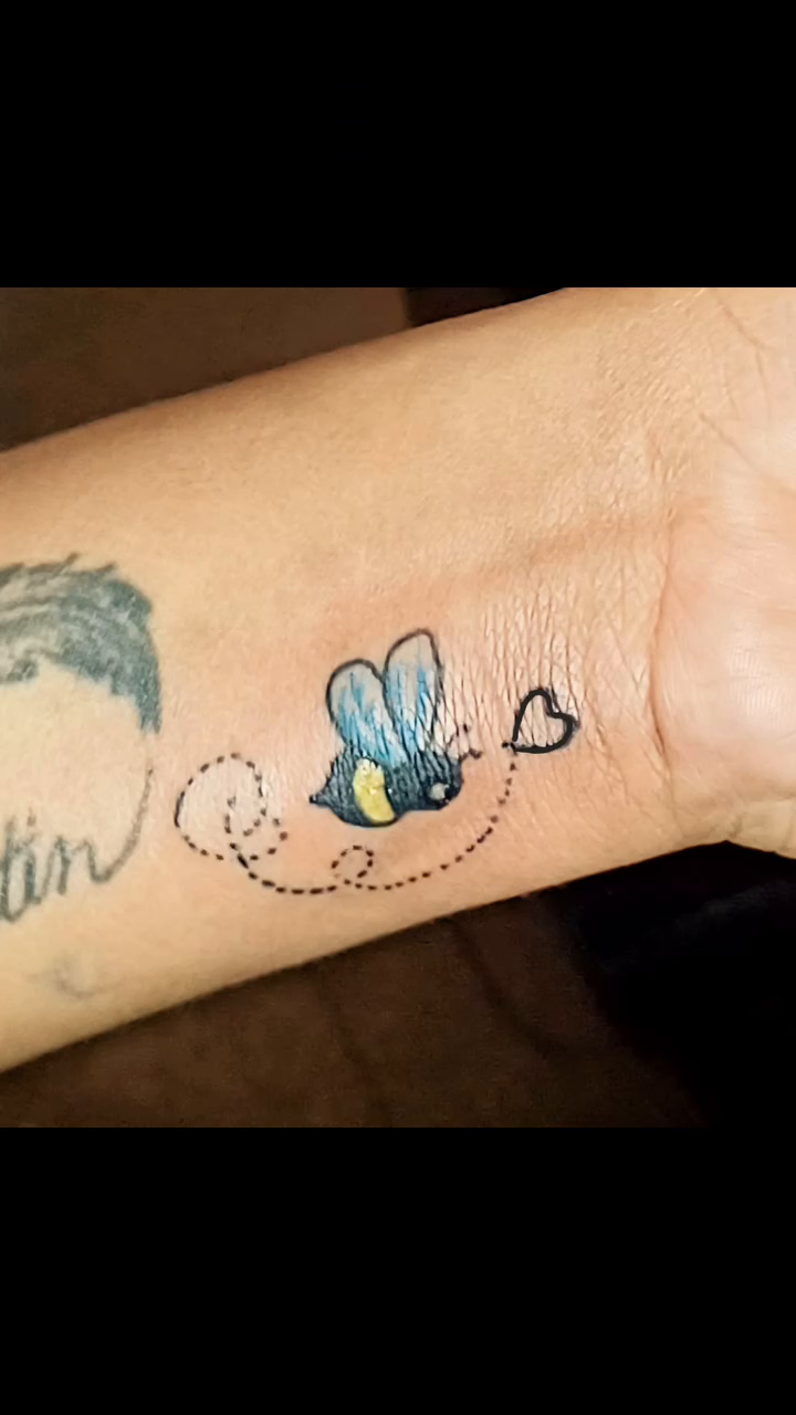Bee with hearts tattoo on the forearm by Miami Beach Tattoo Artist