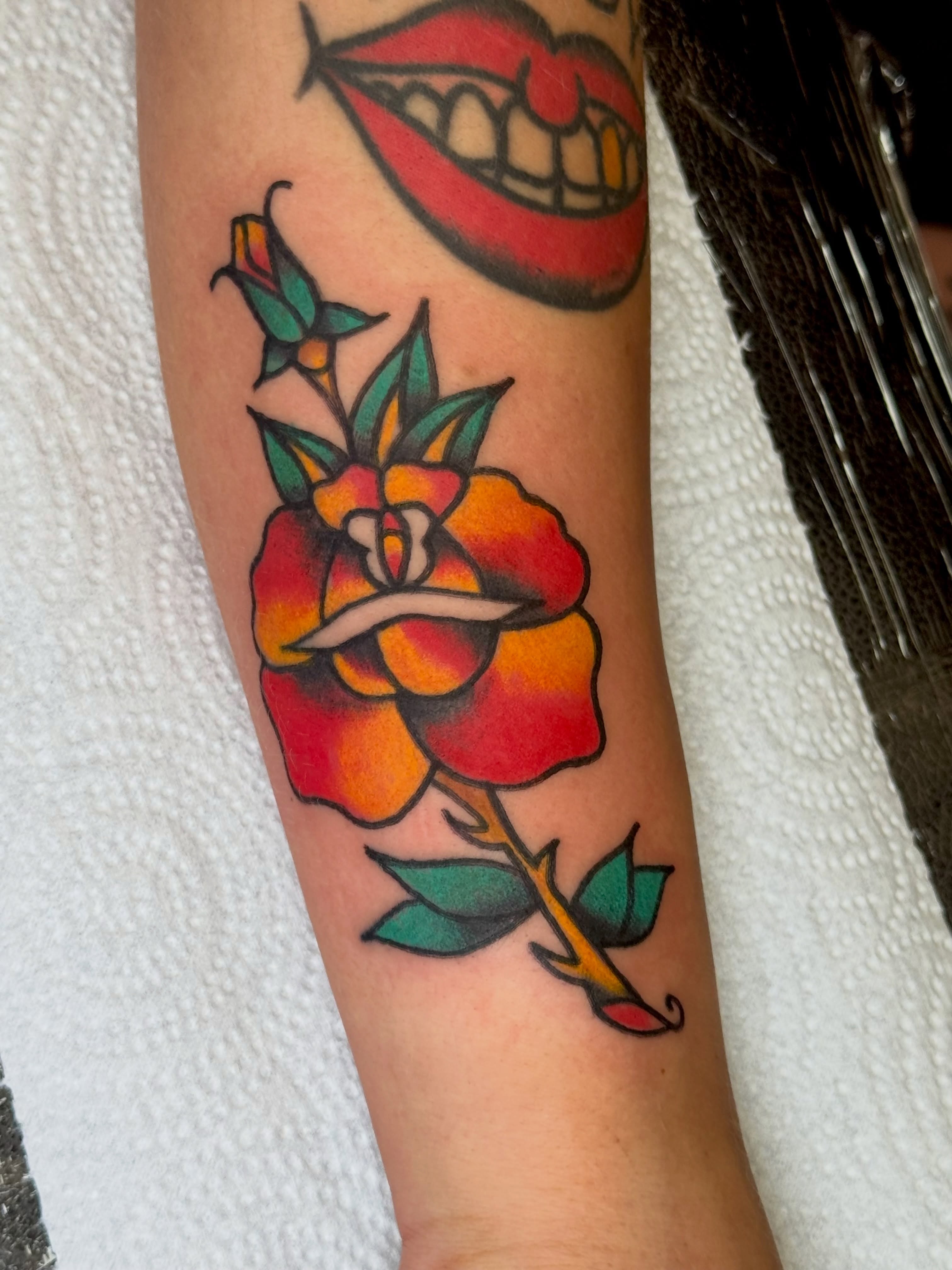 Rose American traditional tattoo on the forearm by Erica Mirella