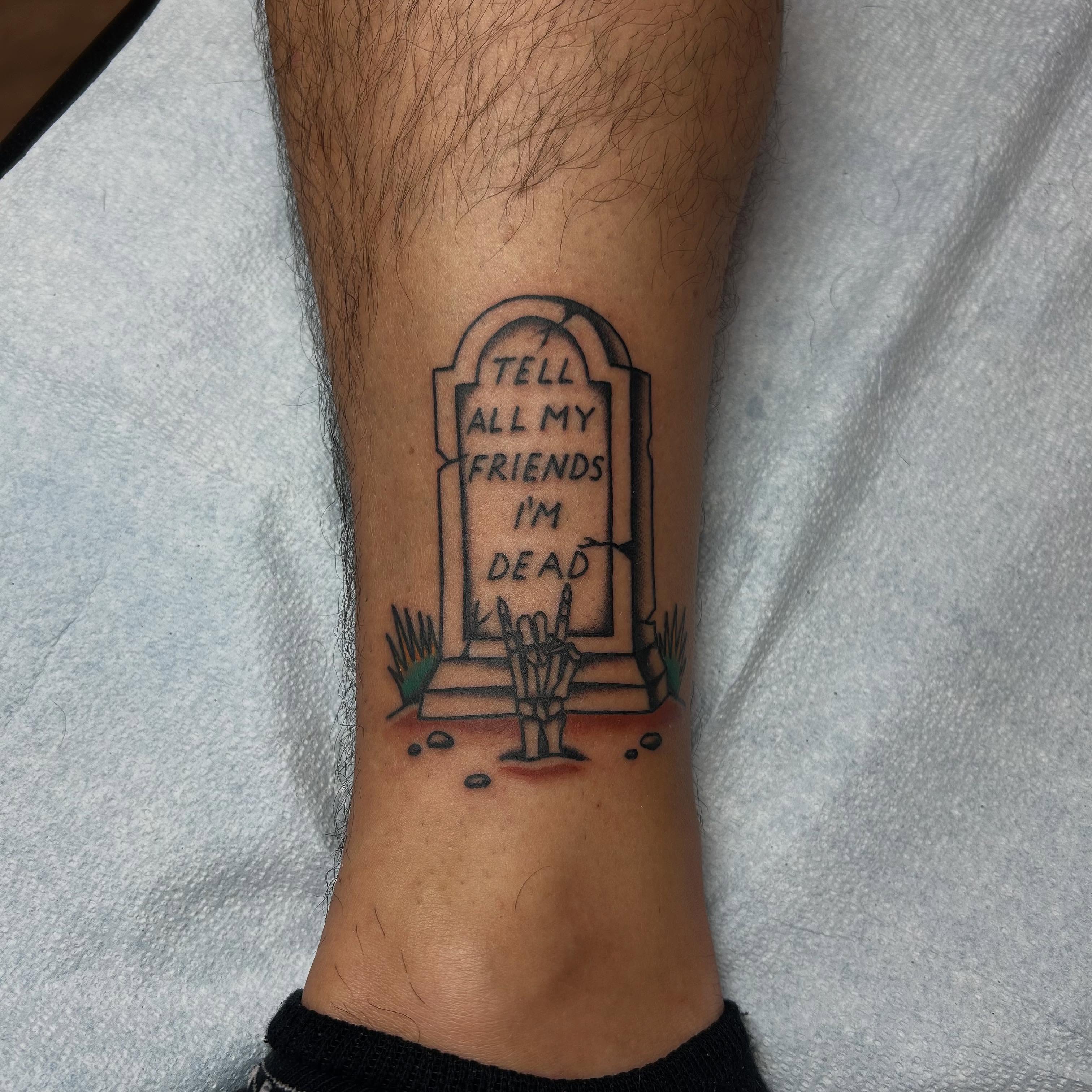 Graveyard with skeleton hand black and grey tattoo on the forearm by Stephen Sanchez