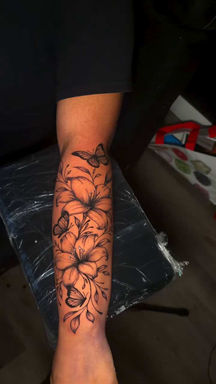 Floral sleeve with butterflies fine line tattoo on the forearm by @getmoneetattz