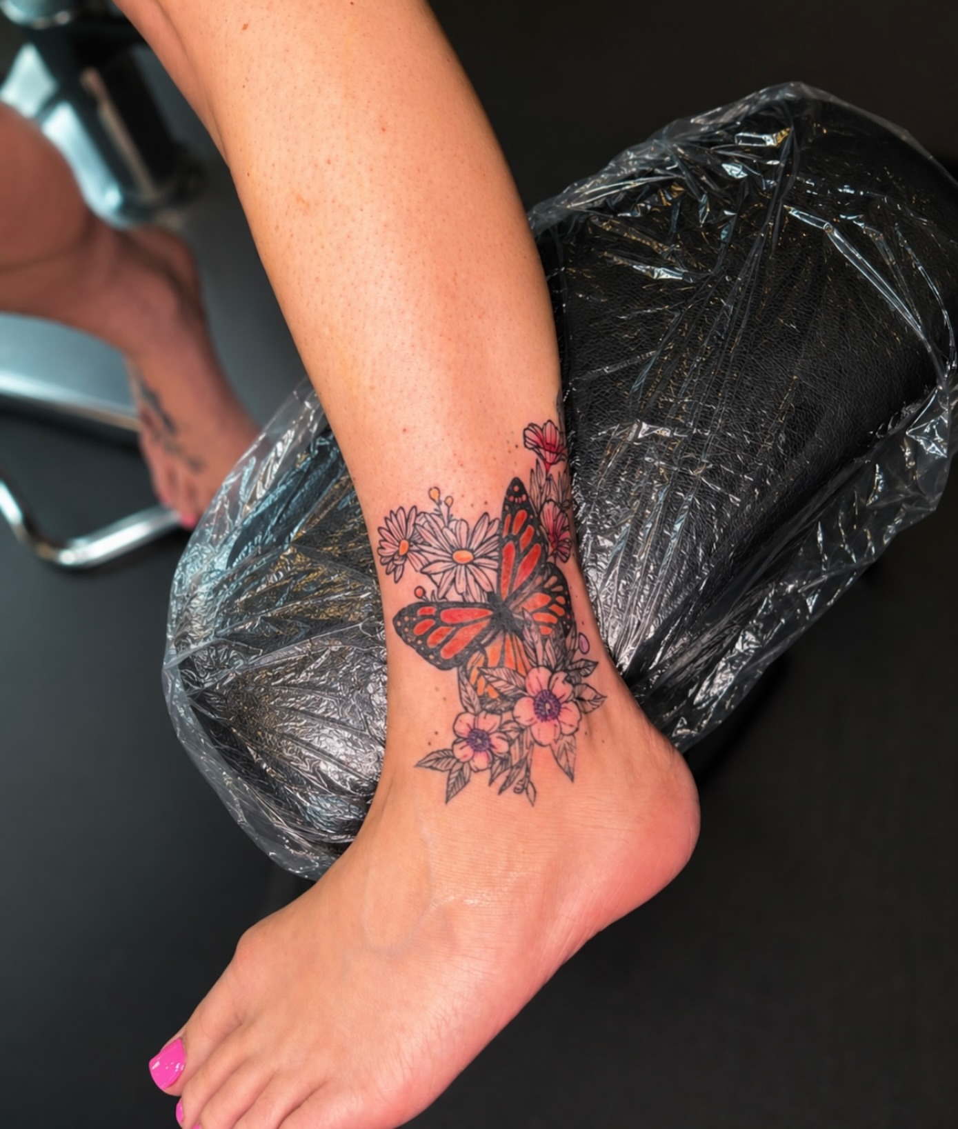 Butterfly and flowers new school tattoo on the foot by Cece, Las Vegas, Nevada