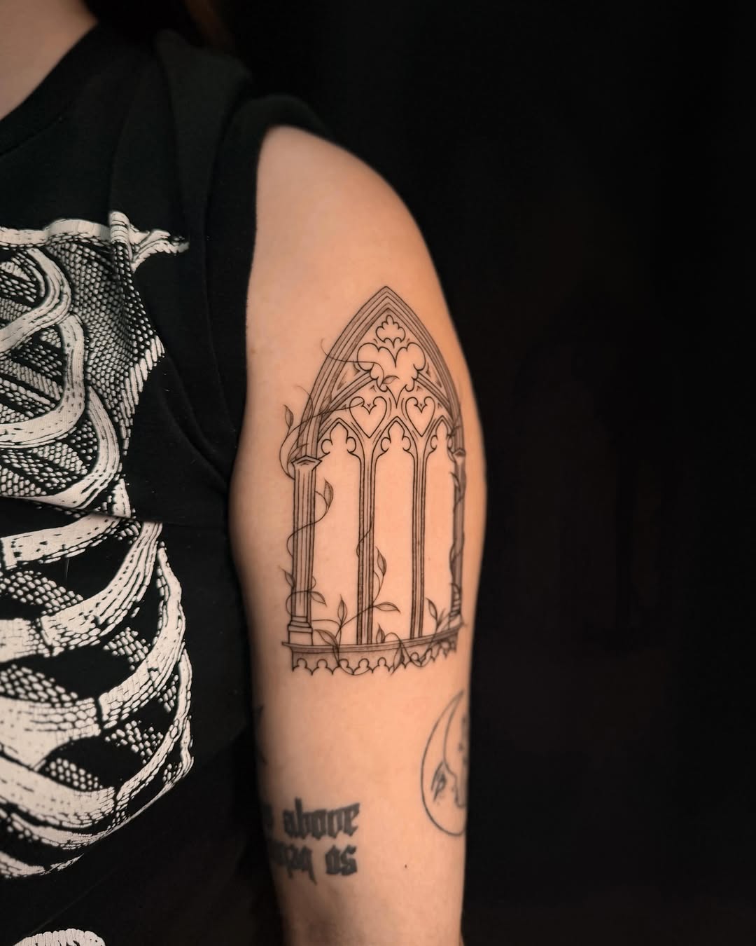 Gothic window with vines minimalist tattoo on the forearm by Frida Tattooista