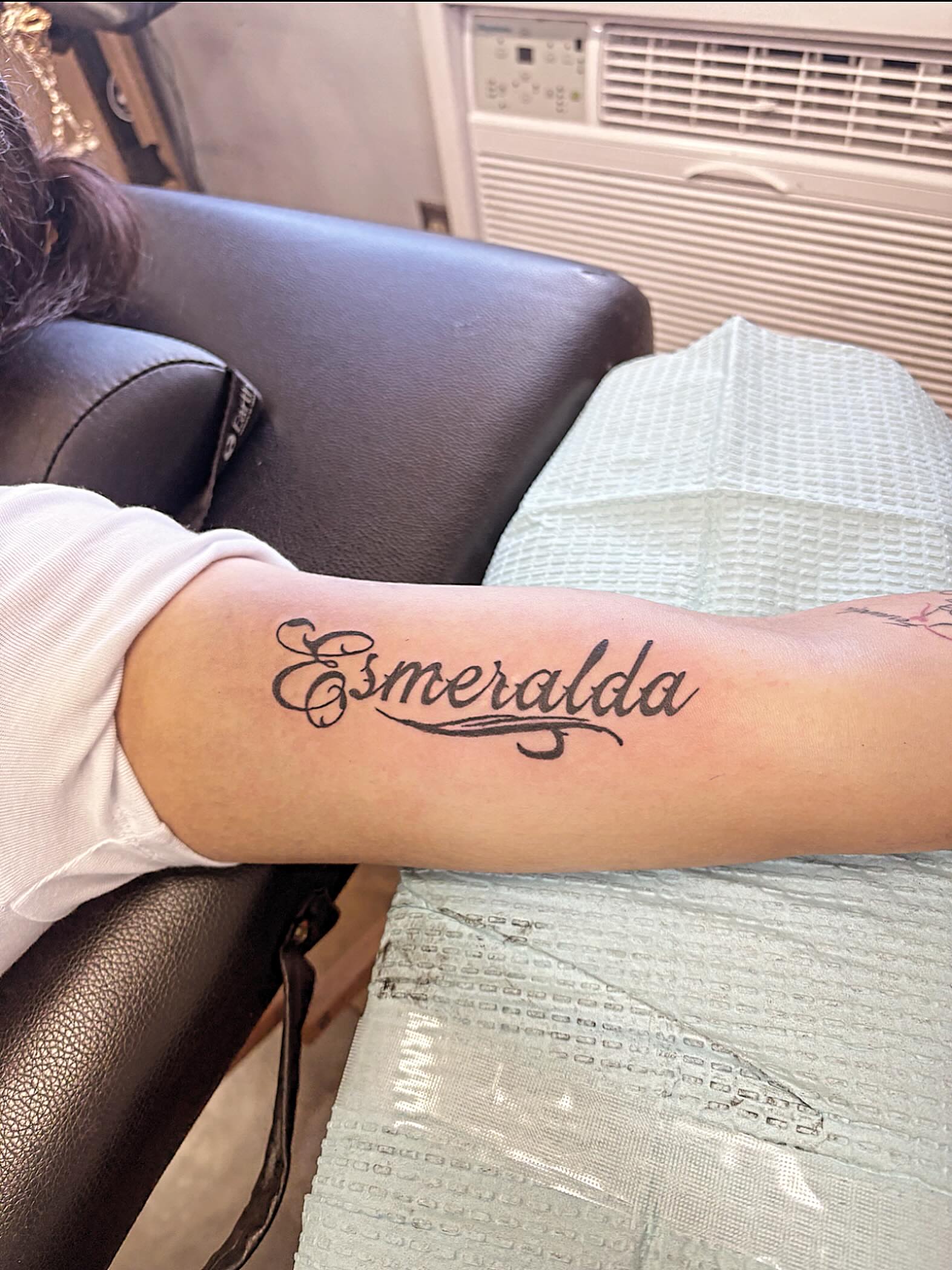 Esmeralda lettering script tattoo on the forearm by Stoney