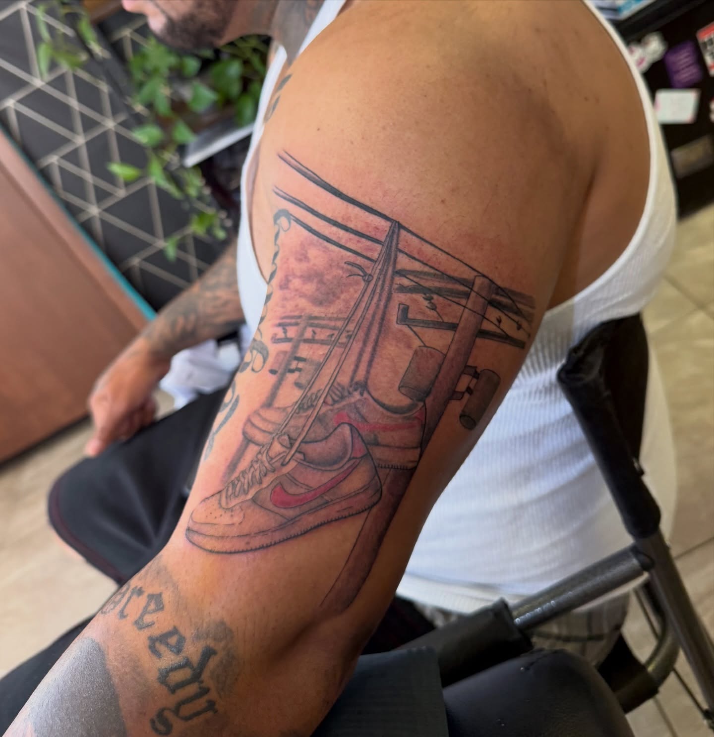 Sneaker and skateboard realism tattoo on the upper arm by XoticTherapy, Las Vegas, Nevada