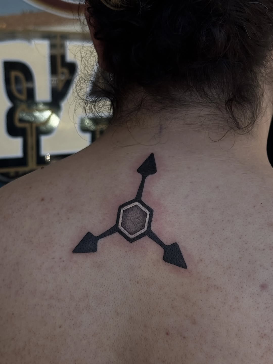 Geometric symbol with arrows geometric tattoo on the back by Cielle