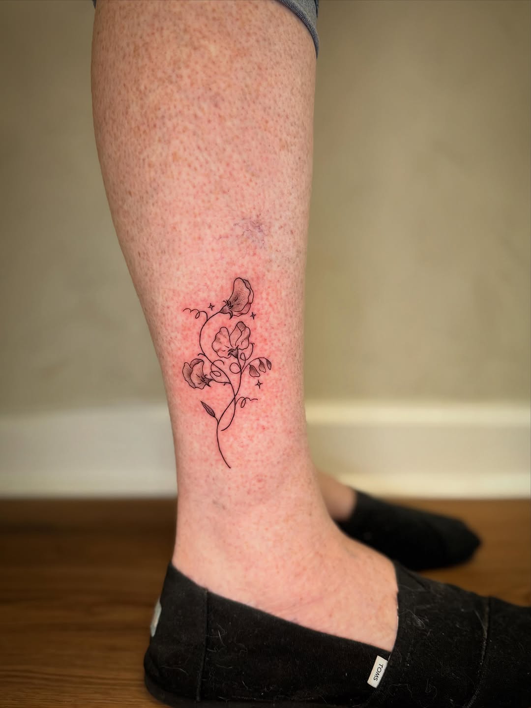 Sweet pea flowers ornamental tattoo on the calf by Danny Garcia