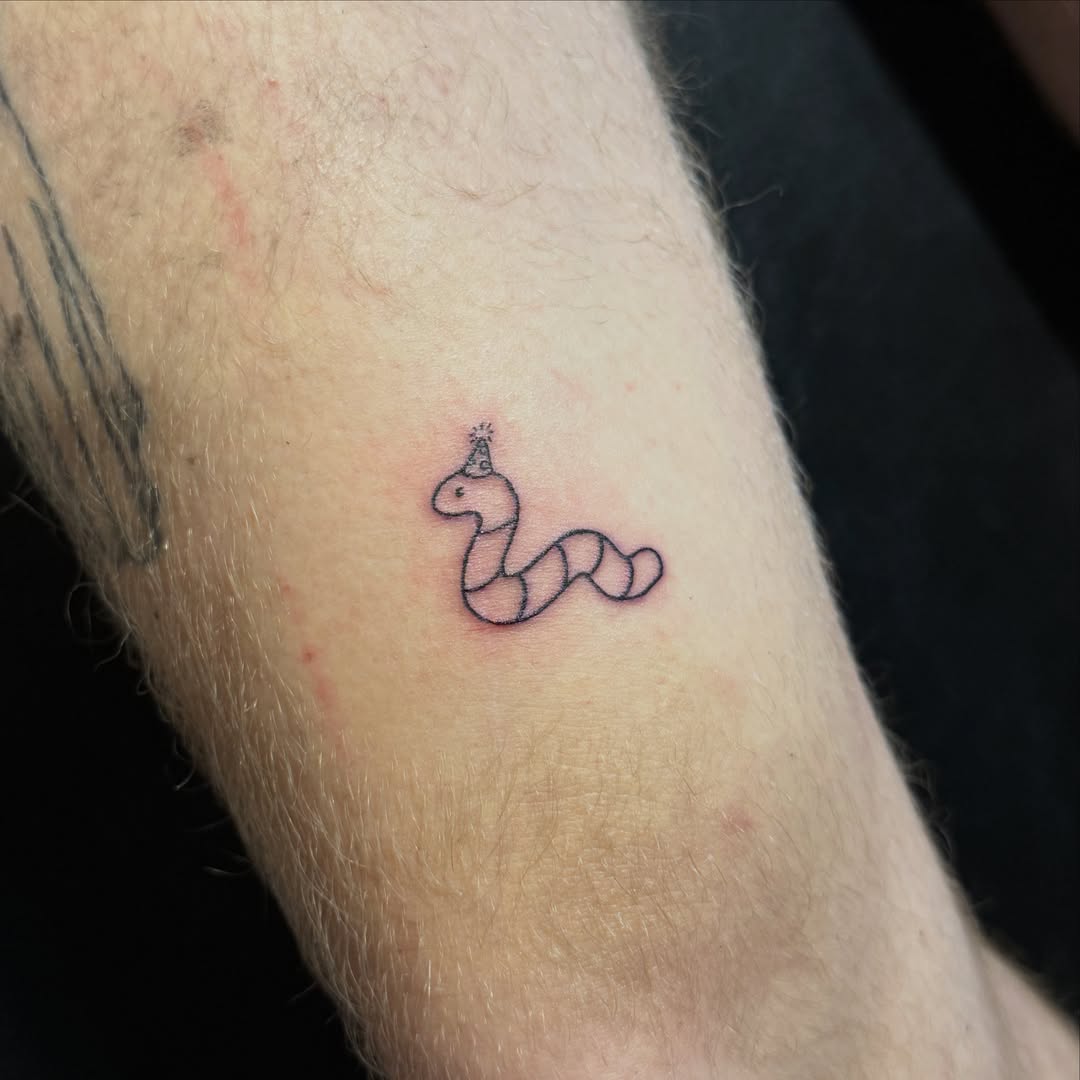 Snake minimalist tattoo on the forearm by Caroline at Lettie Grace Ink