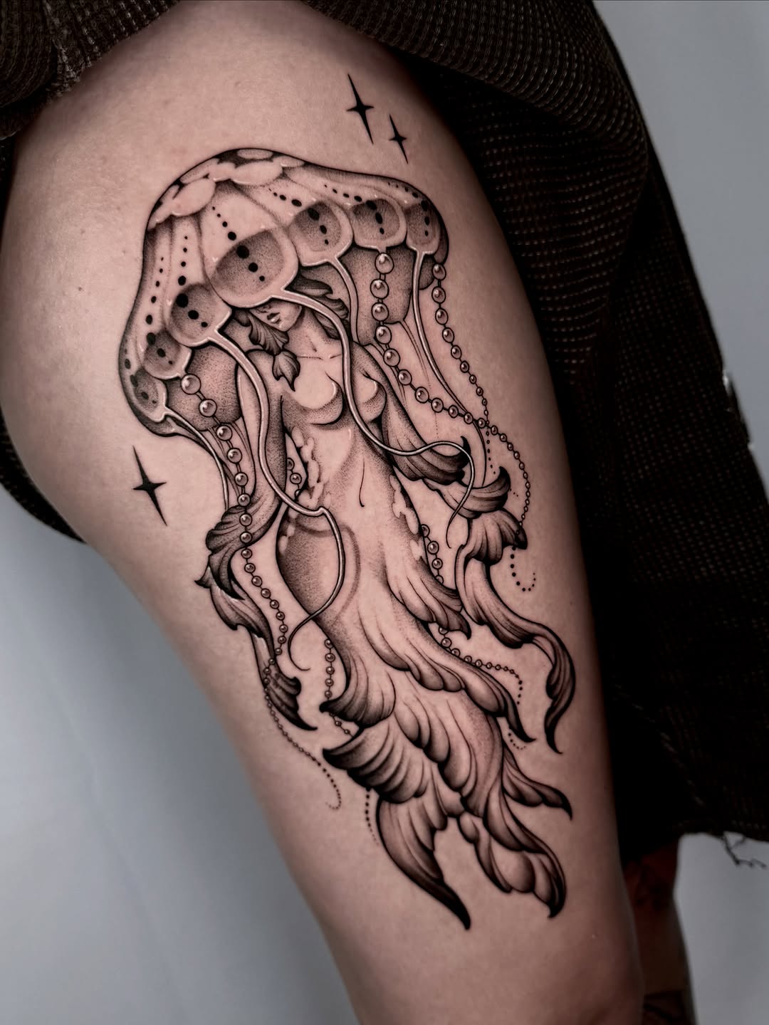 Jellyfish with a woman's face realism tattoo on the thigh by Kathryn Semus