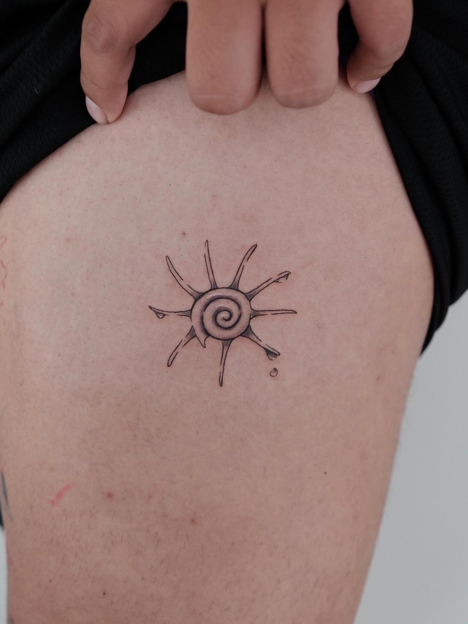 Sun geometric tattoo on the thigh by Elana Hites
