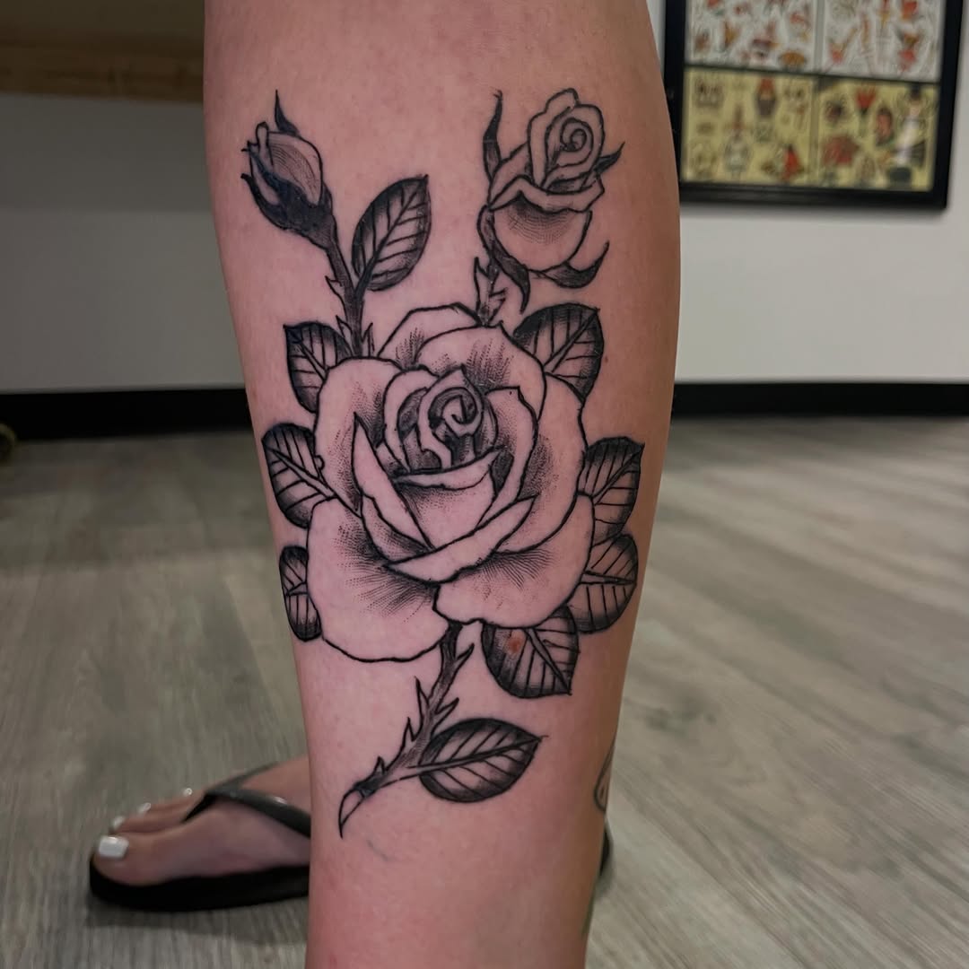 Rose and buds dotwork tattoo on the calf by Logan Casimir