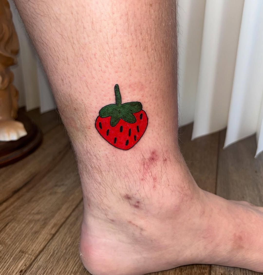 Strawberry new school tattoo on the calf by riley