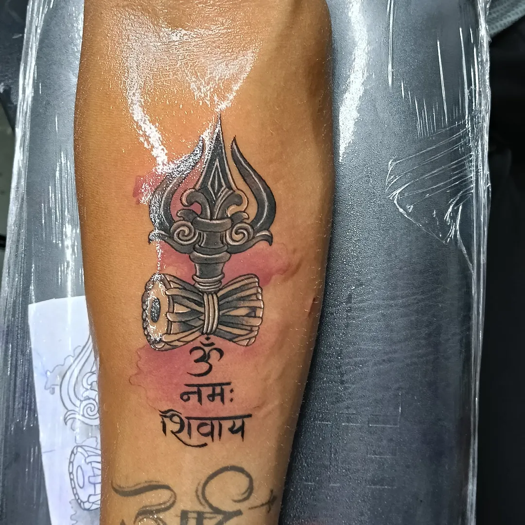 Trident and script black and grey tattoo on the forearm by VR tattoo Studio