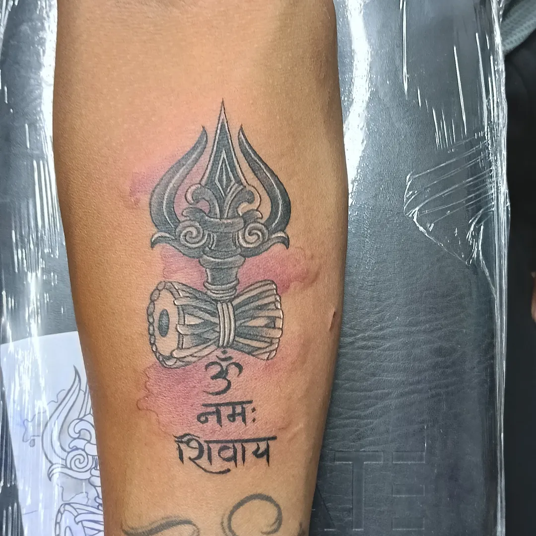 Trident and drum black and grey tattoo on the forearm by VR tattoo Studio