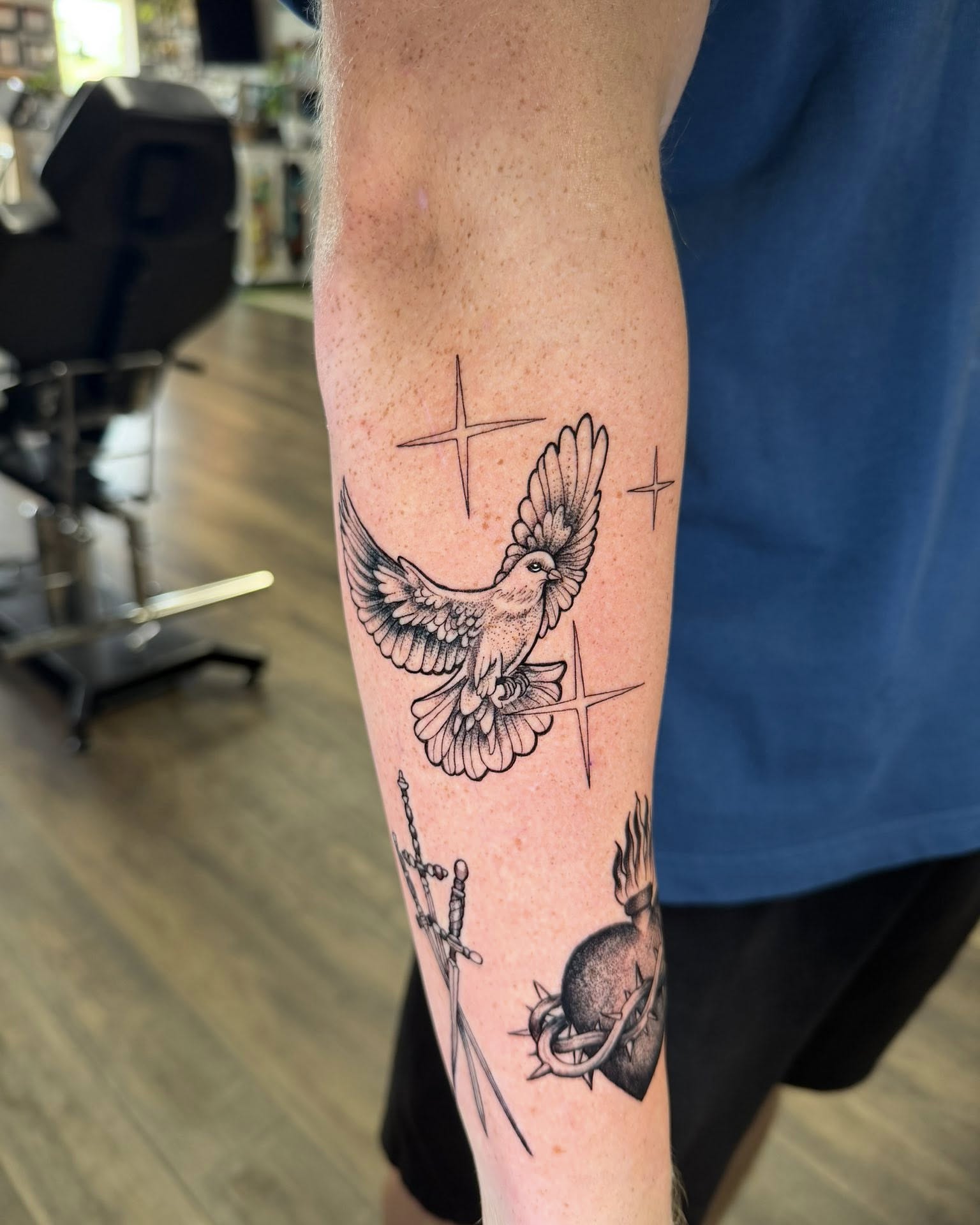 Bird and stars dotwork tattoo on the forearm by Chad Meado