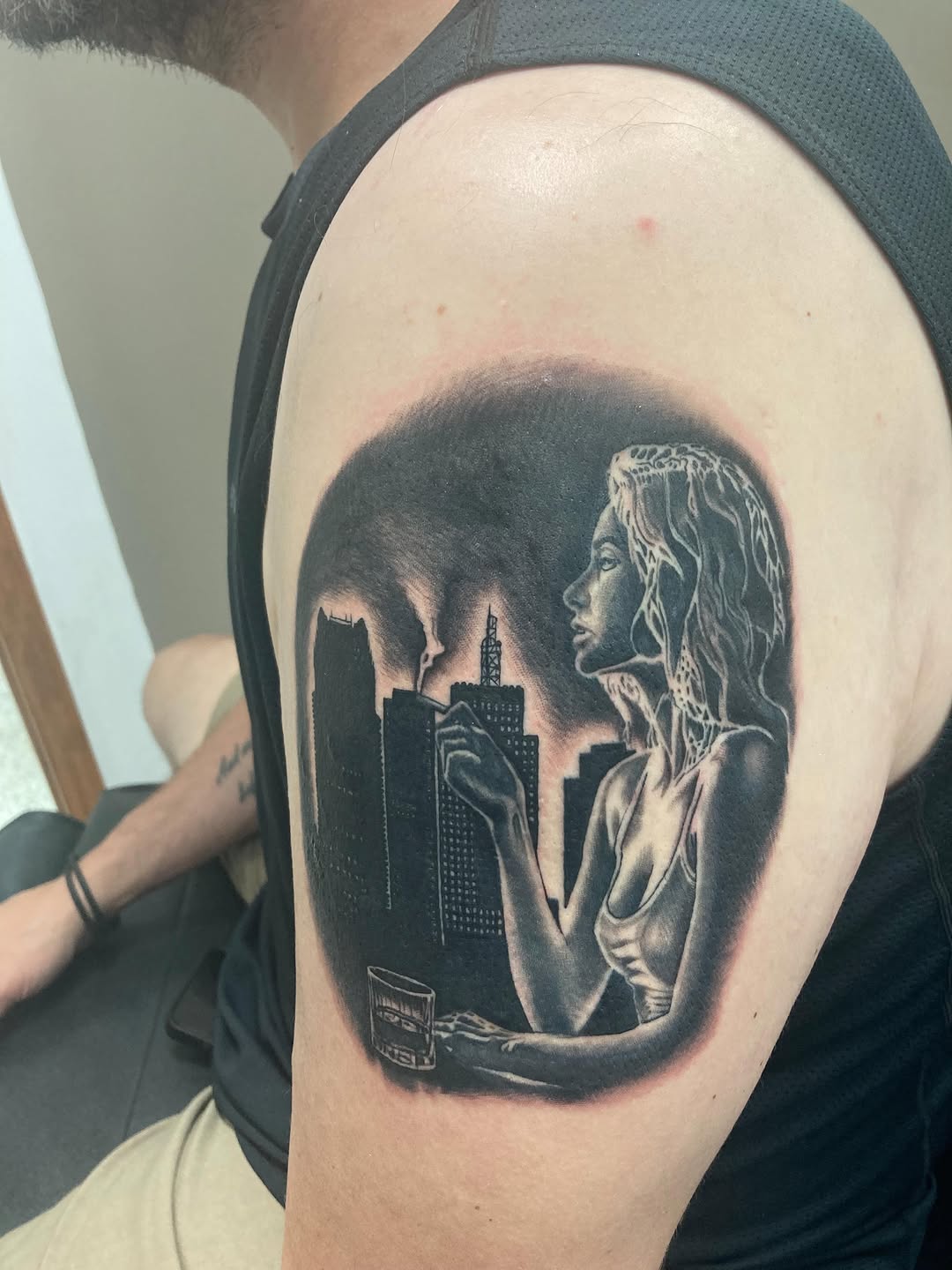 Woman smoking in city realism tattoo on the shoulder by Timothy Murtaugh