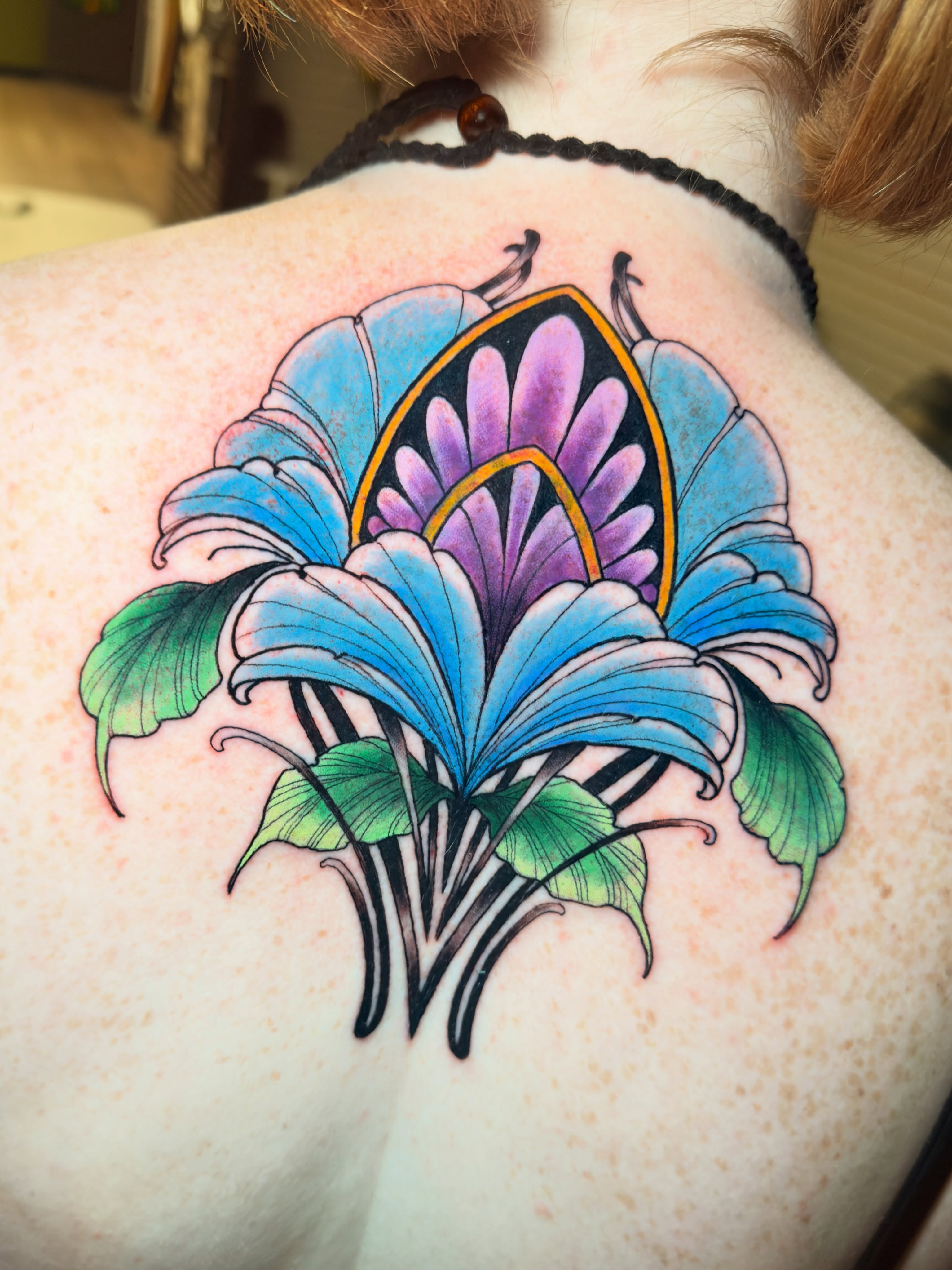 Lily American traditional tattoo on the shoulder by Jenn Golgan